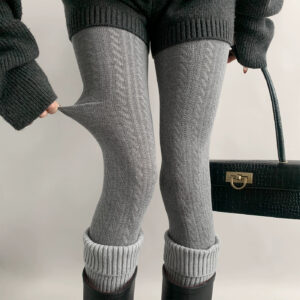 Gray Jirai Kei hollow vertical stripe knit tights front close-up showing twisted texture detail with studio lighting