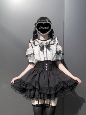 Jirai Kei off-shoulder blouse black white colorway front view on model with heart face shield gothic lolita aesthetic ruffle neckline