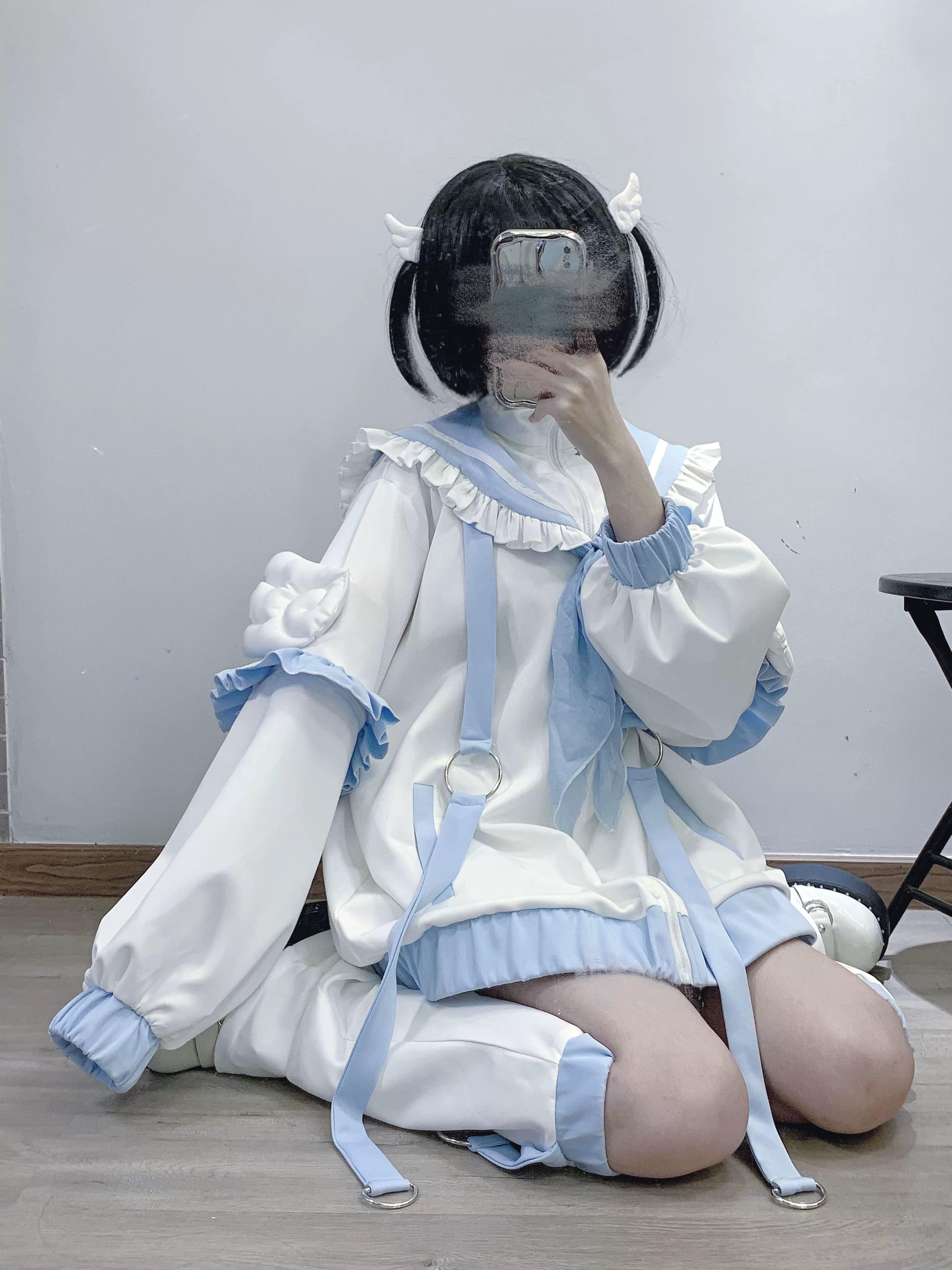 Tenshi Kaiwai oversized sailor jacket set full-body kneeling side view matching leg warmers extended sleeves ethereal silhouette