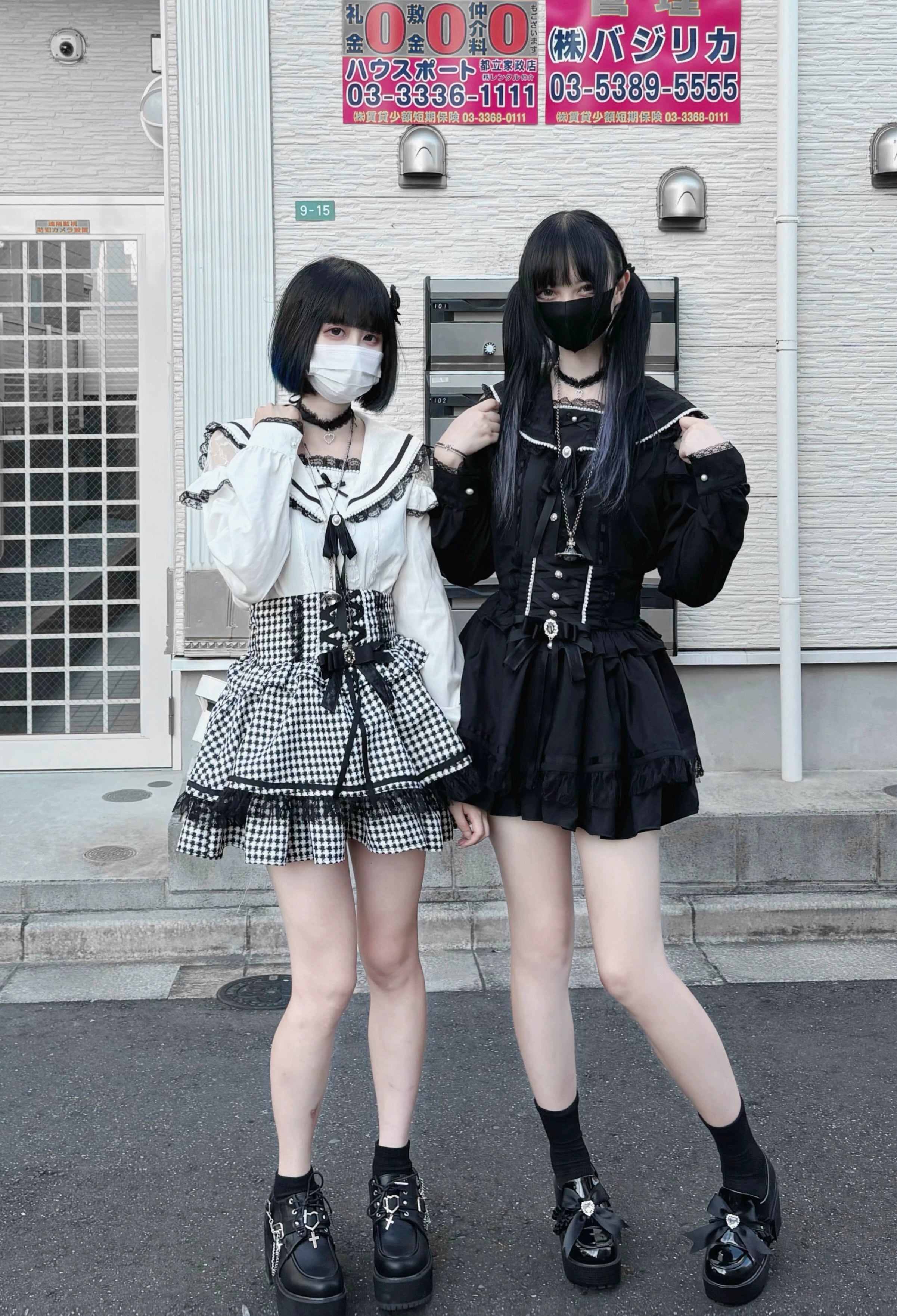 Two masked female models wearing Jirai Kei sailor collar blouses with matching gingham check skirts and platform loafers outdoors, showcasing complete street fashion ensemble with sailor collar details and complementary accessories