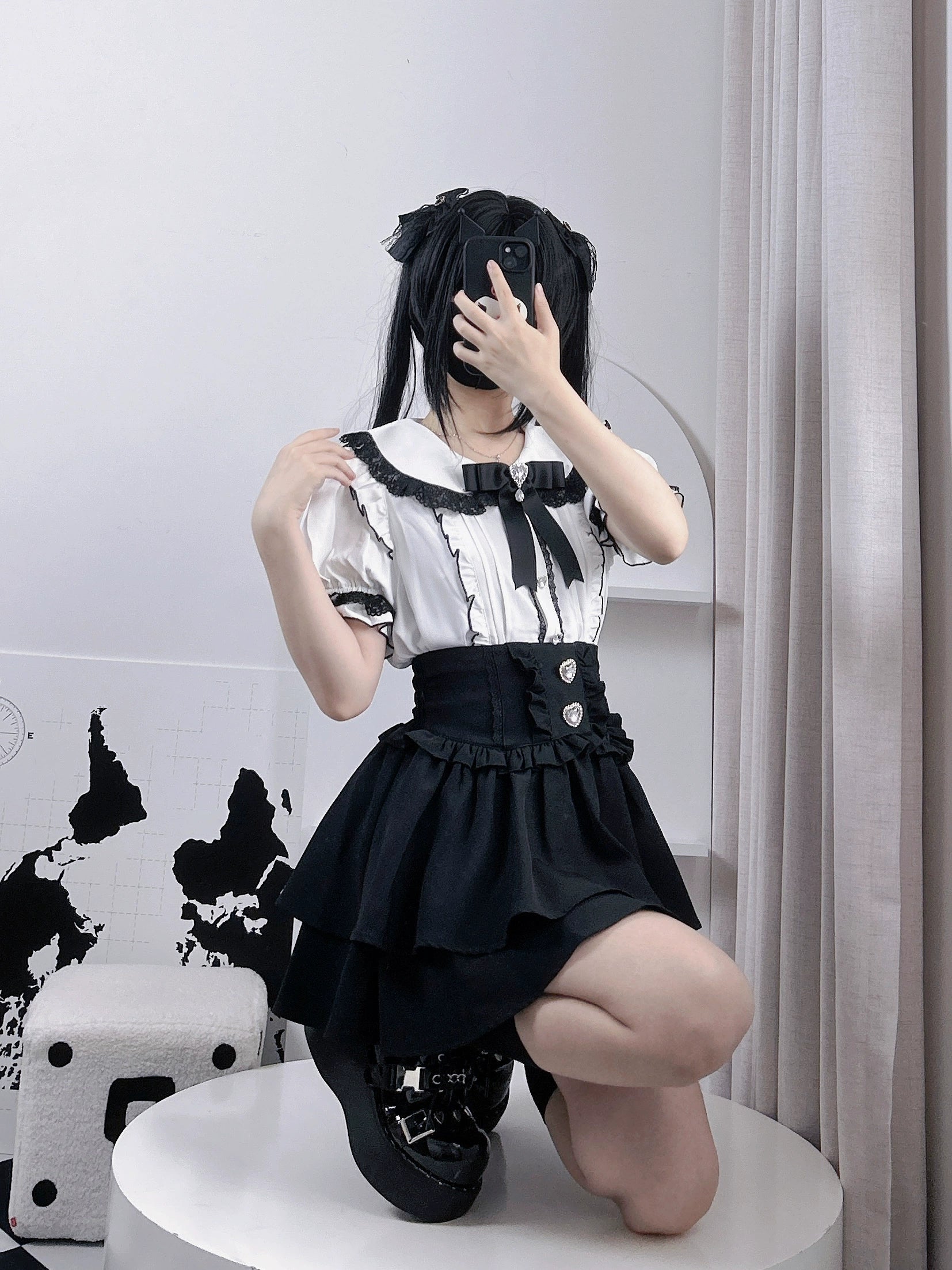 Black and white plaid jirai kei tiered skirt detail view, geometric pattern with layered ruffle construction, classic jirai kei design