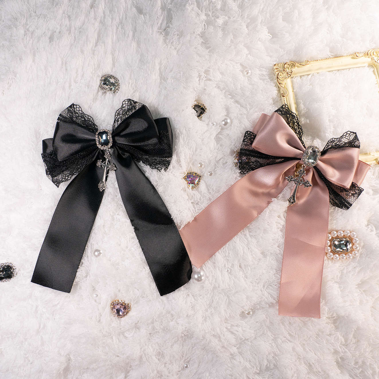 Jirai Kei lace cross bow brooch hair clip in pink and black color variants displayed on white plush backdrop with rhinestone accents