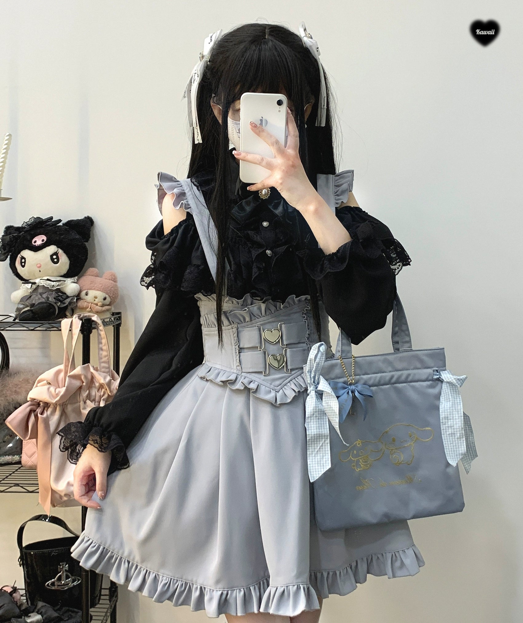 Aqua colored Jirai Kei suspender skirt with ruffled hem and heart-shaped buckle waistband styled in doll-themed interior setting