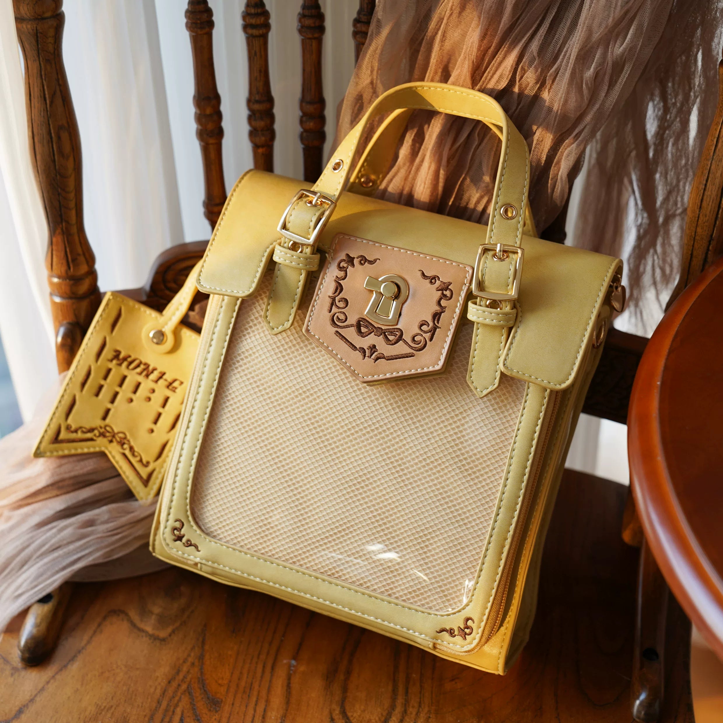 Mustard yellow premium vintage Jirai Kei ita satchel bag with luxurious embroidery details and clear window for anime badge showcase, warm jewel tone color