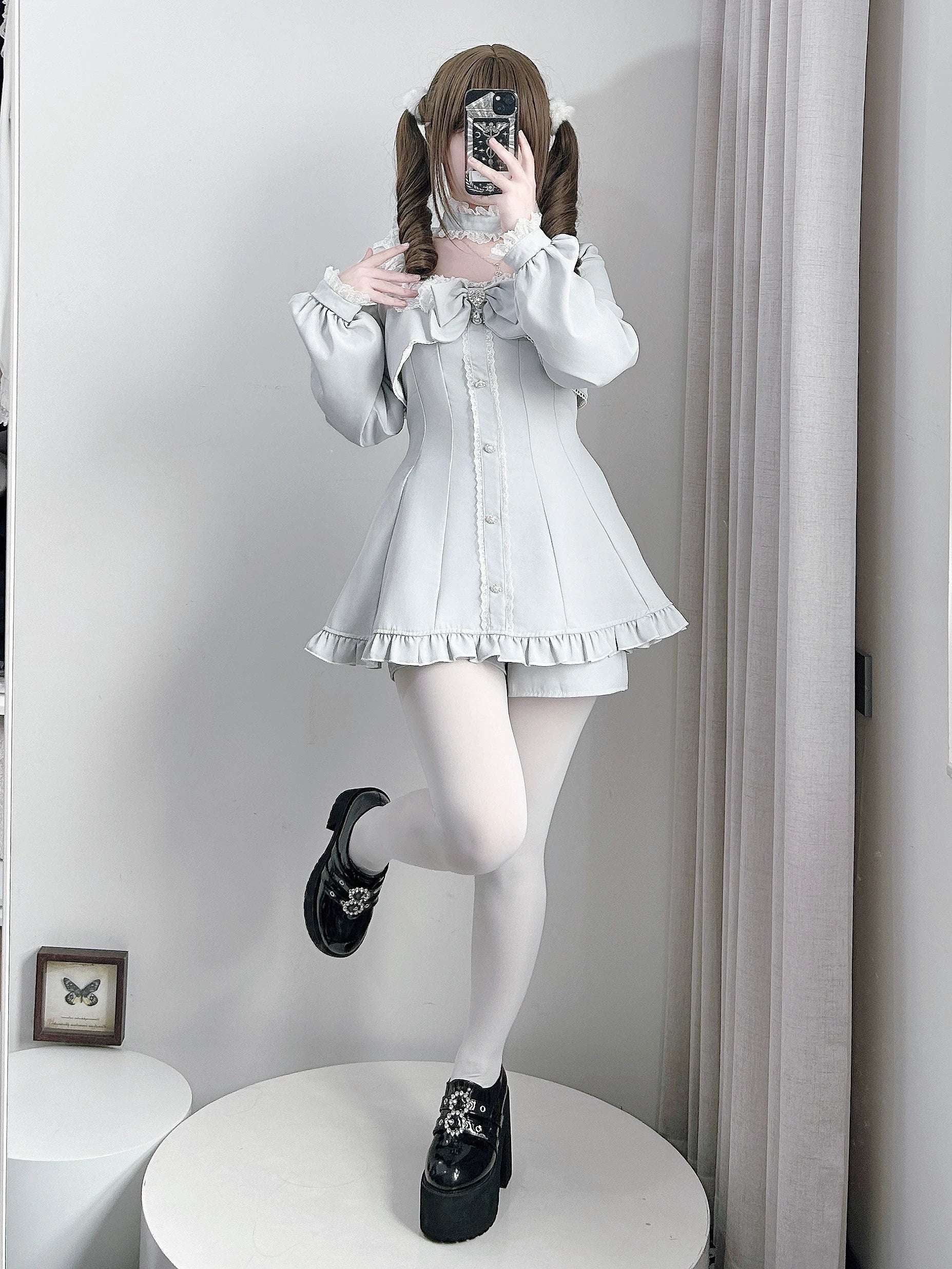Jirai Kei gothic long-sleeve dress detail highlighting square neckline, layered ruffled construction, and rhinestone embellishments close-up