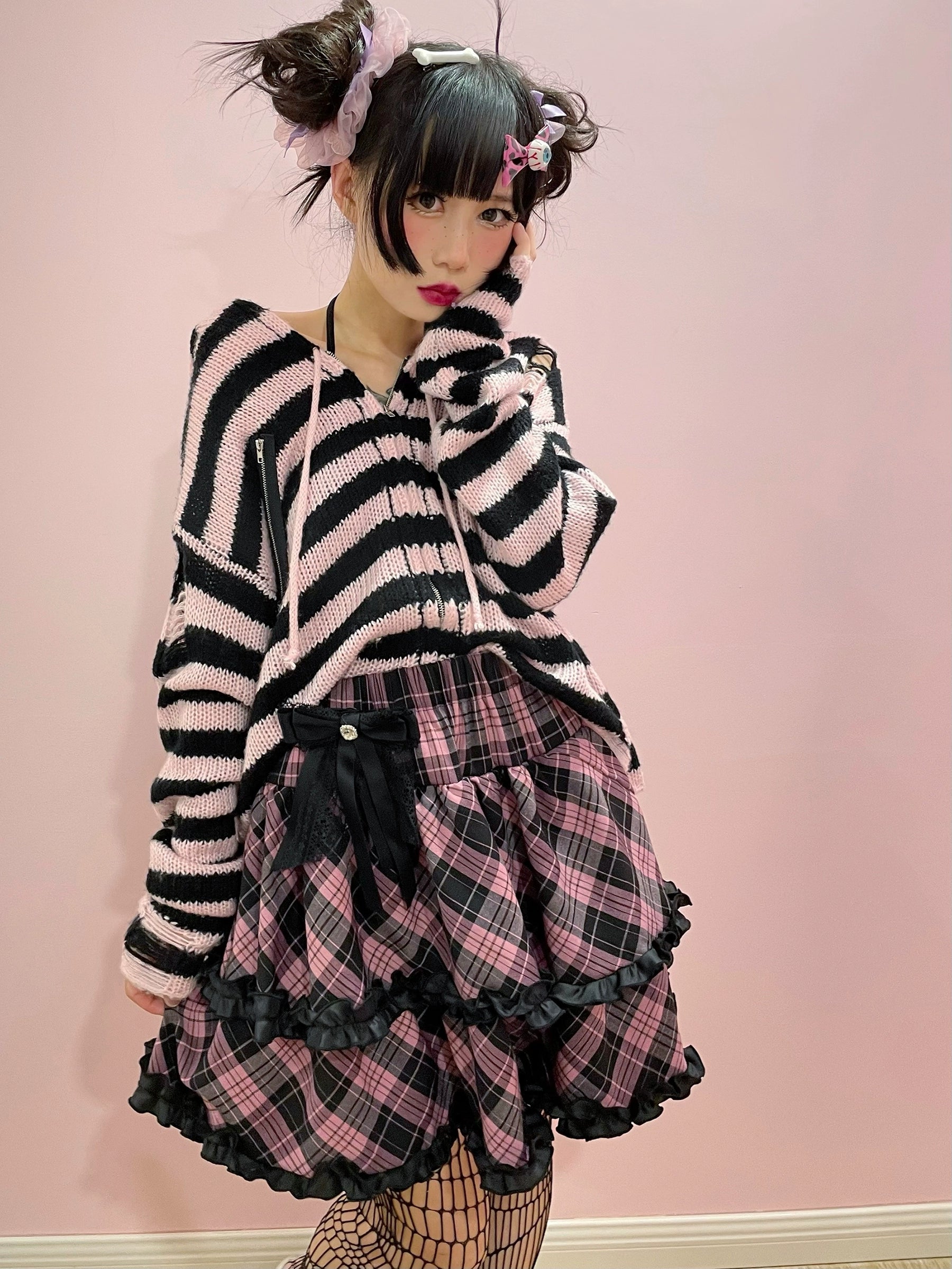 Pink-black plaid Jirai Kei ruffle mini skirt black frilled trim detail, layered ruffles showcase, high-waist silhouette close-up