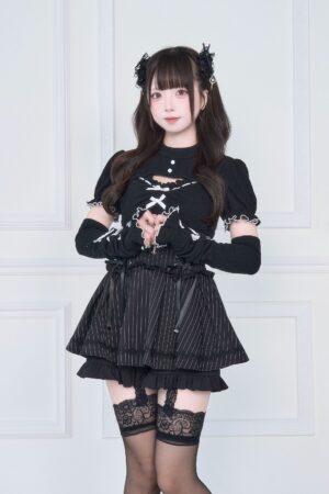 Black Jirai Kei cutout knit top with striped ruffle skirt lace-up front full body view - subculture style set