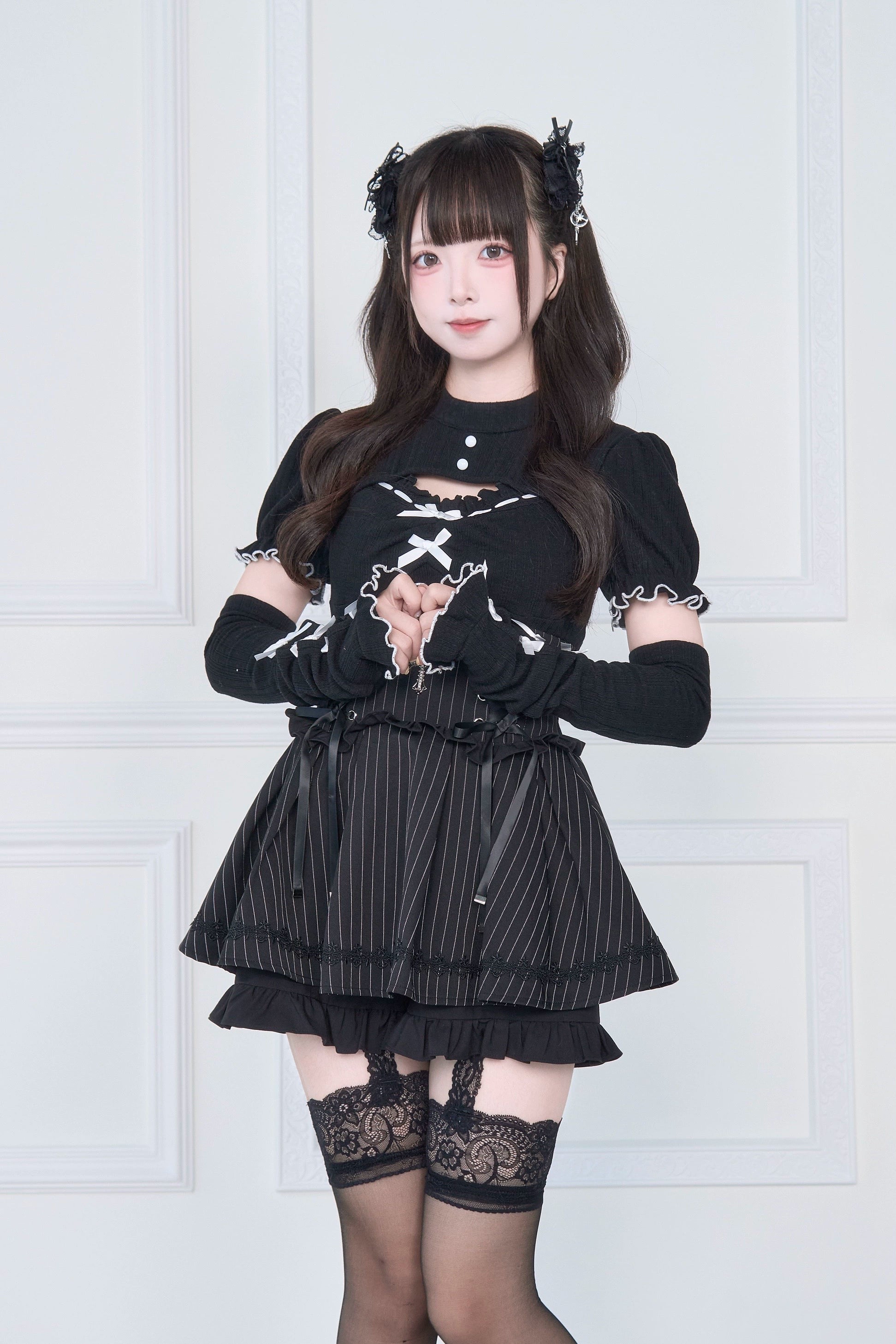 Black Jirai Kei cutout knit top with striped ruffle skirt lace-up front full body view - subculture style set