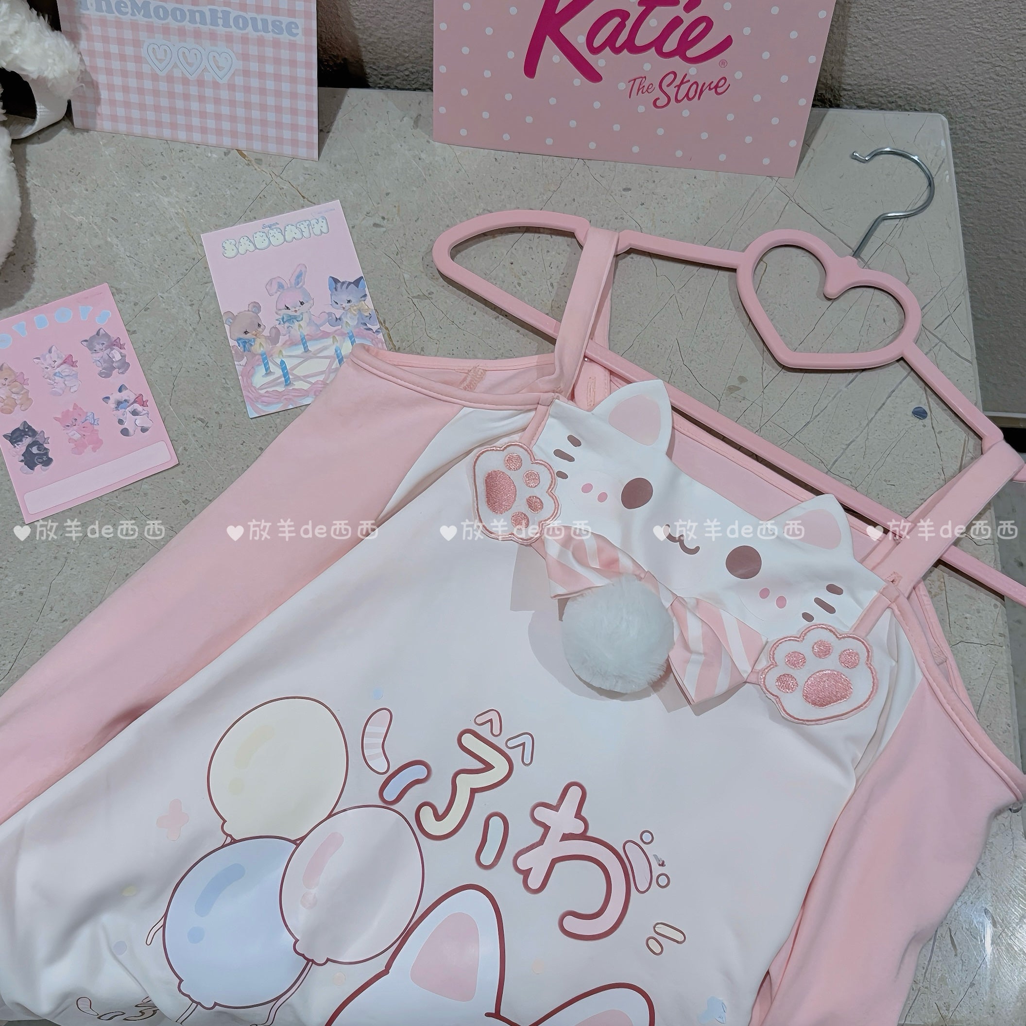 Complete Jirai Kei cat-print coordinate set with all components including off-shoulder top, multi-layer pink skirt, white fuzzy choker, interchangeable straps, and embellishments in overhead flat lay