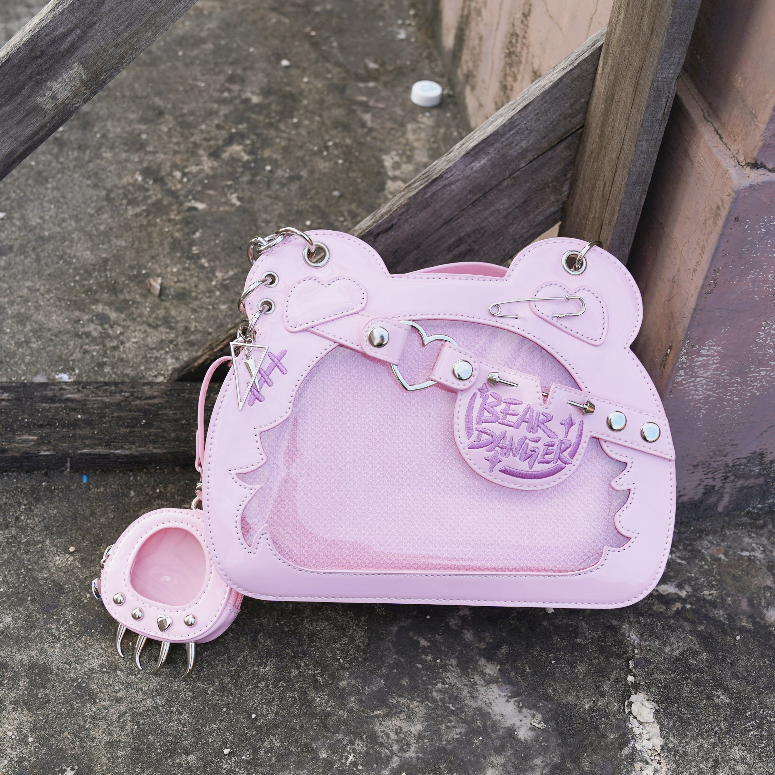 Pink patent leather bear-shaped jirai kei ita bag with playful punk metal embellishments and detachable bear paw coin purse