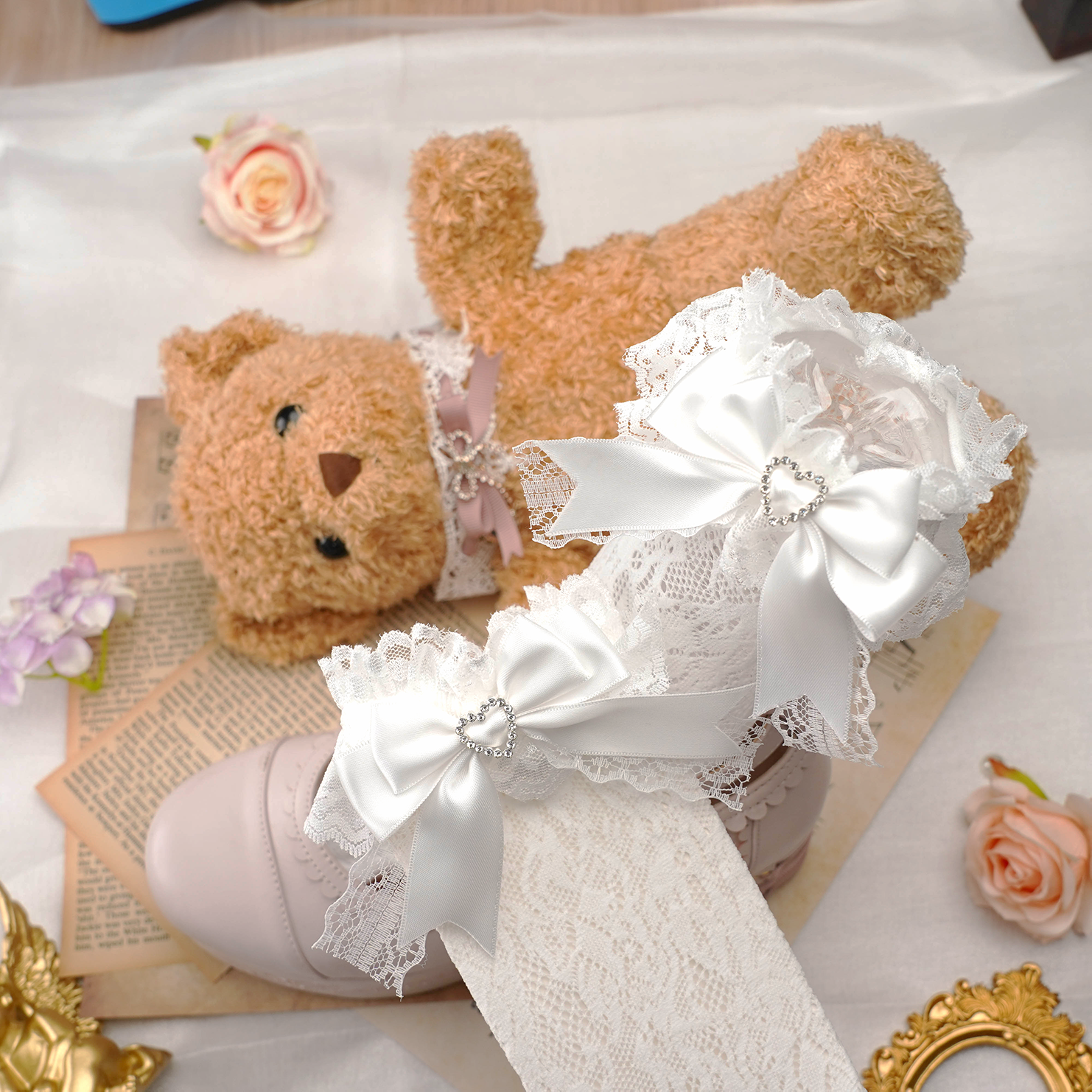 Jirai kei lace socks featuring heart-shaped rhinestones and decorative satin bows in soft color palette displayed with artistic flat lay styling