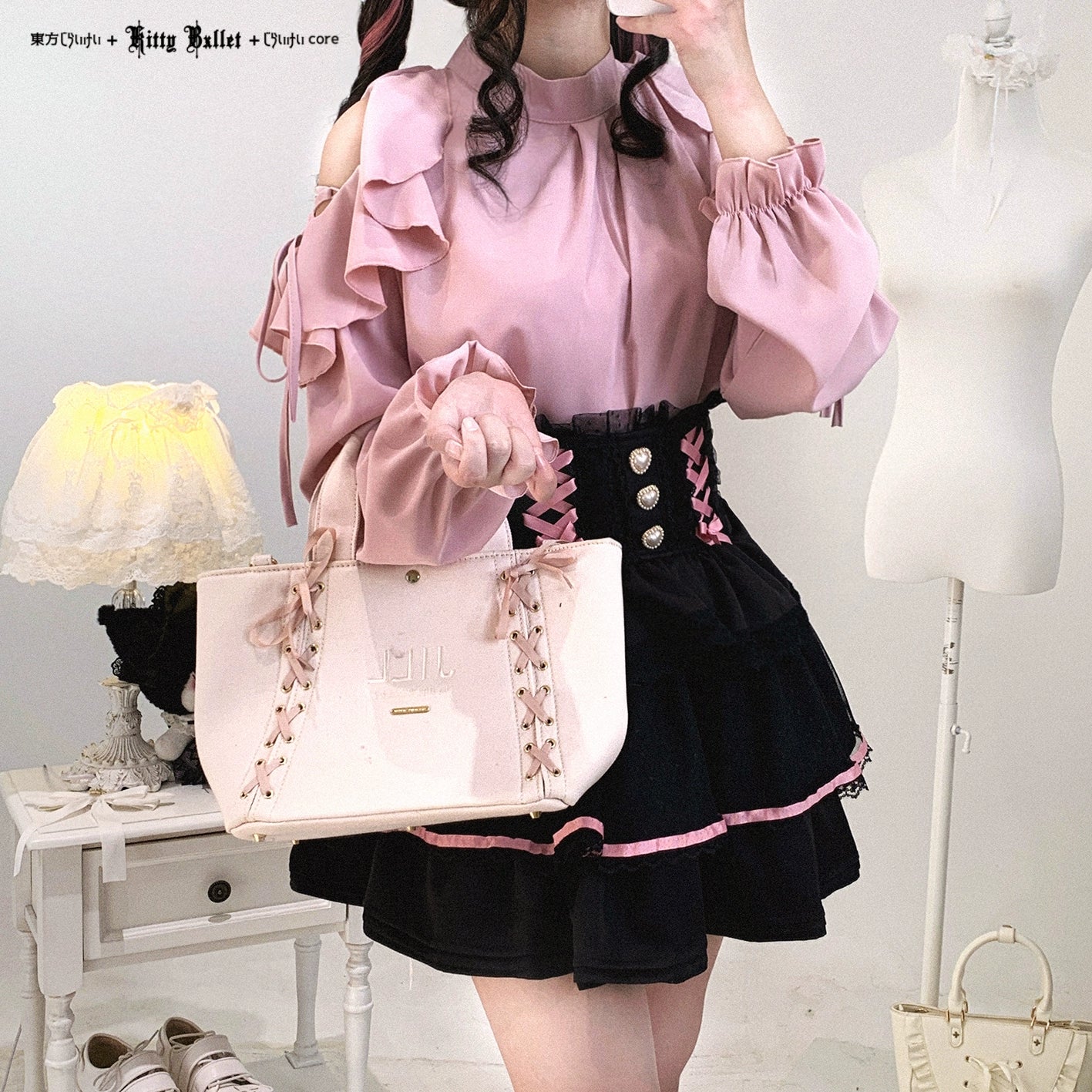 Pink cold-shoulder ruffled blouse Jirai Kei styled with black high-waist skirt and pink handbag coordinate
