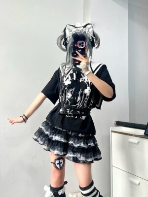 Jirai Kei girl wearing layered lace puff skirt with cat ear twin bun headdress and printed black top mirror selfie three-quarter angle view