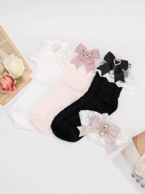Jirai Kei lace socks collection in three color options white black pink with heart rhinestone bow trim and floral pattern detail flat lay