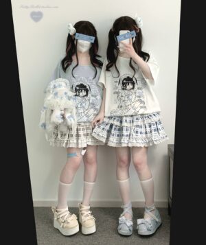 Jirai Kei fashion set with light-toned polo printed top and mixed plaid ruffle mini skirt, modeled by masked twin girls with blue blindfolds taking mirror selfie