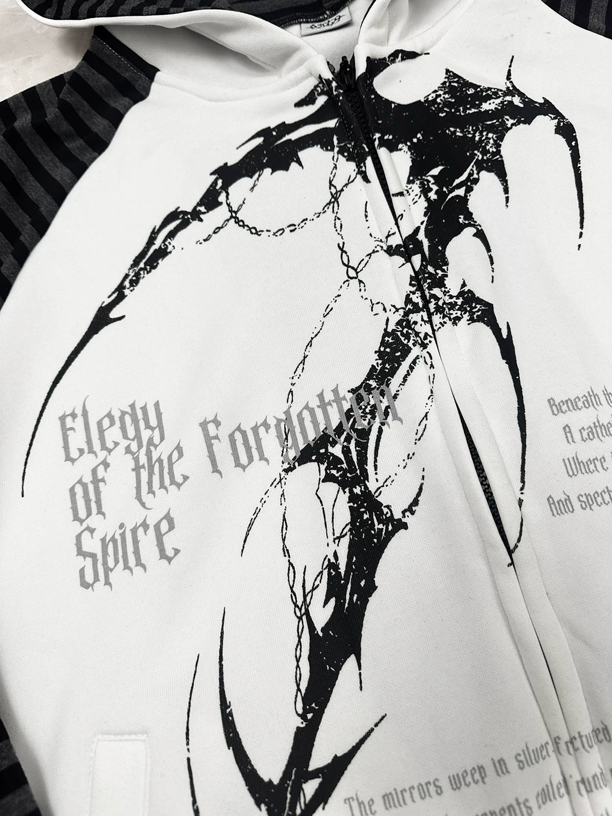 Hooded scythe print zip coat paired with skirt and platform boots creating Jirai Kei contrast of delicate and dark fashion