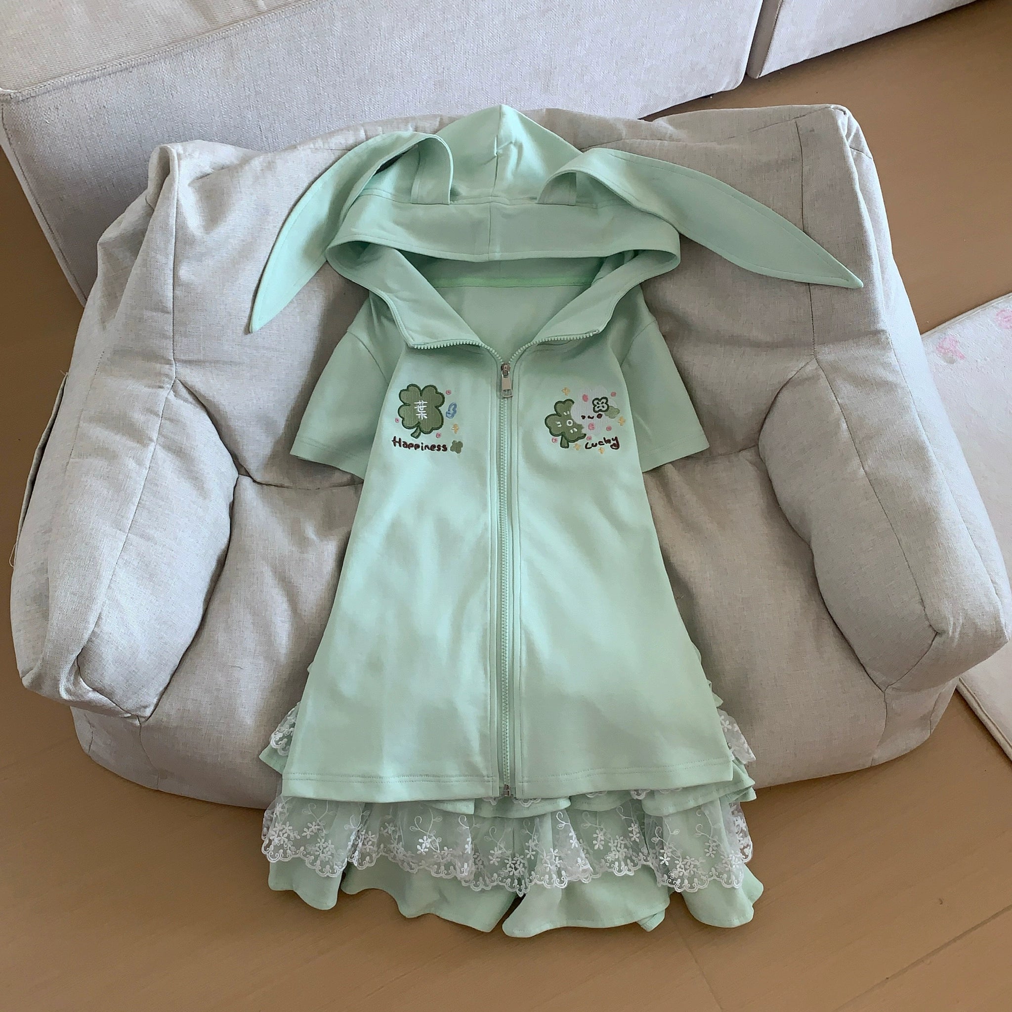 Tiered ruffle lace skirt in mint green Jirai Kei style, front display showing layered ruffle hem, lace paneling, elastic waist, and built-in safety shorts construction