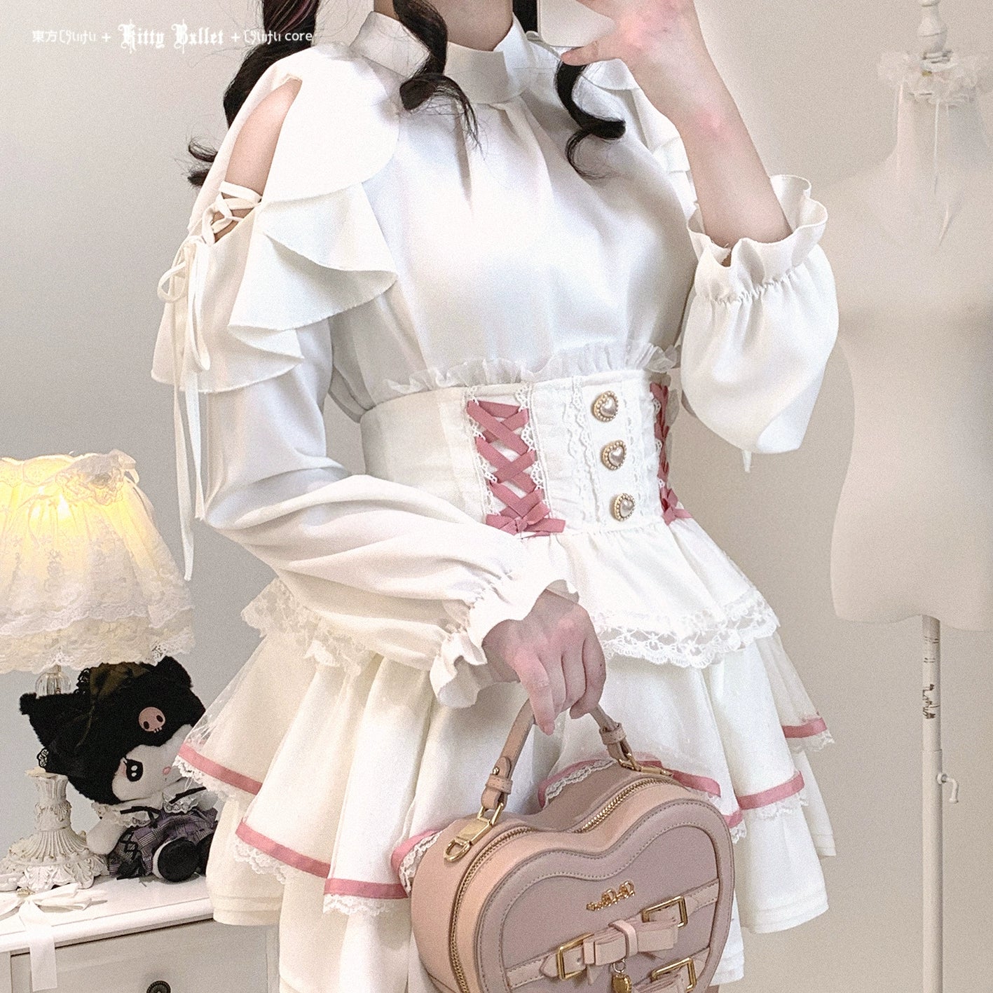 White cold-shoulder ruffled blouse Jirai Kei style matched with white corset skirt heart-shaped handbag