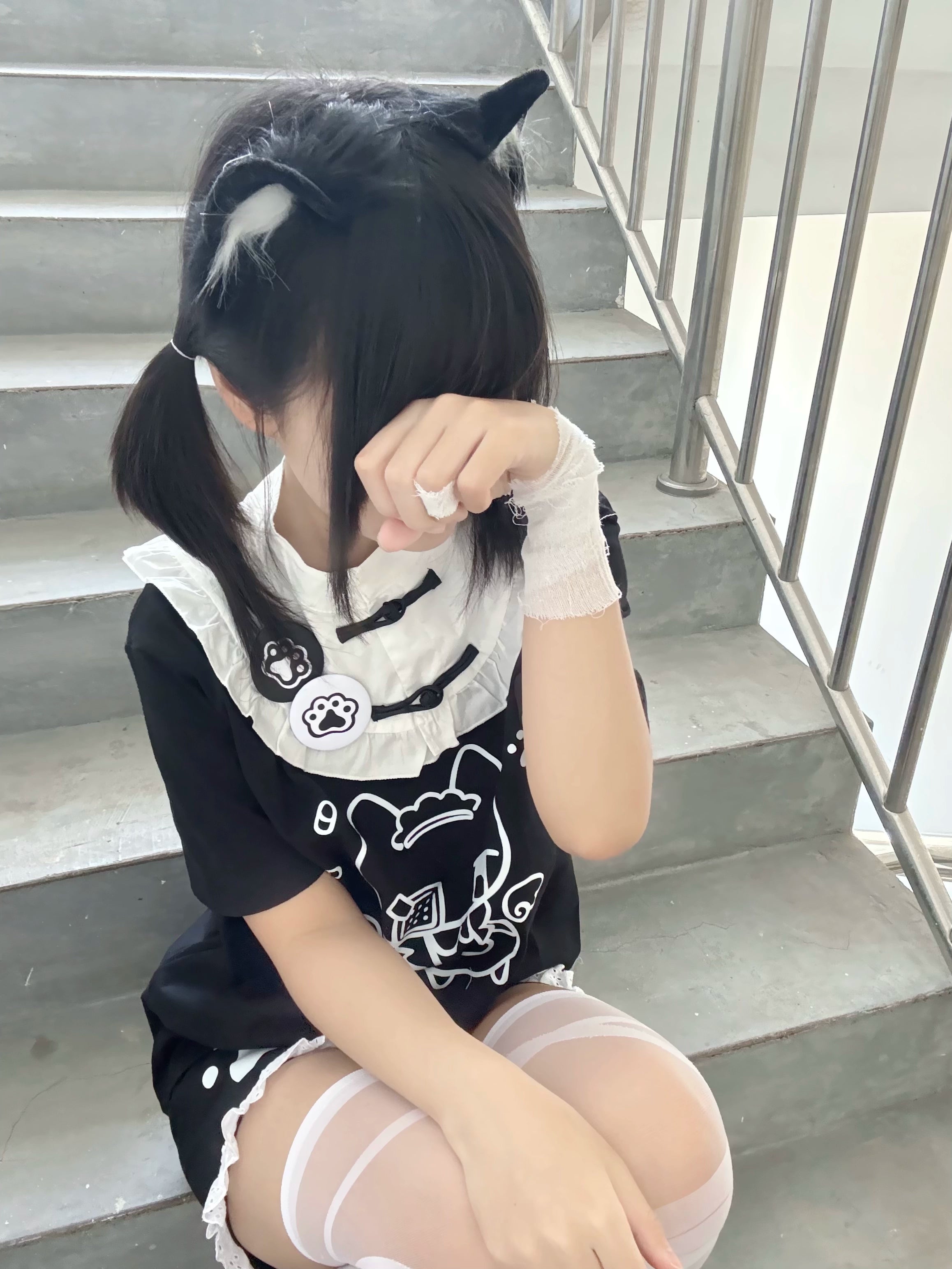 Black Tenshi Kaiwai cat-themed cotton T-shirt overhead sitting view with cat ear accessories staircase scene