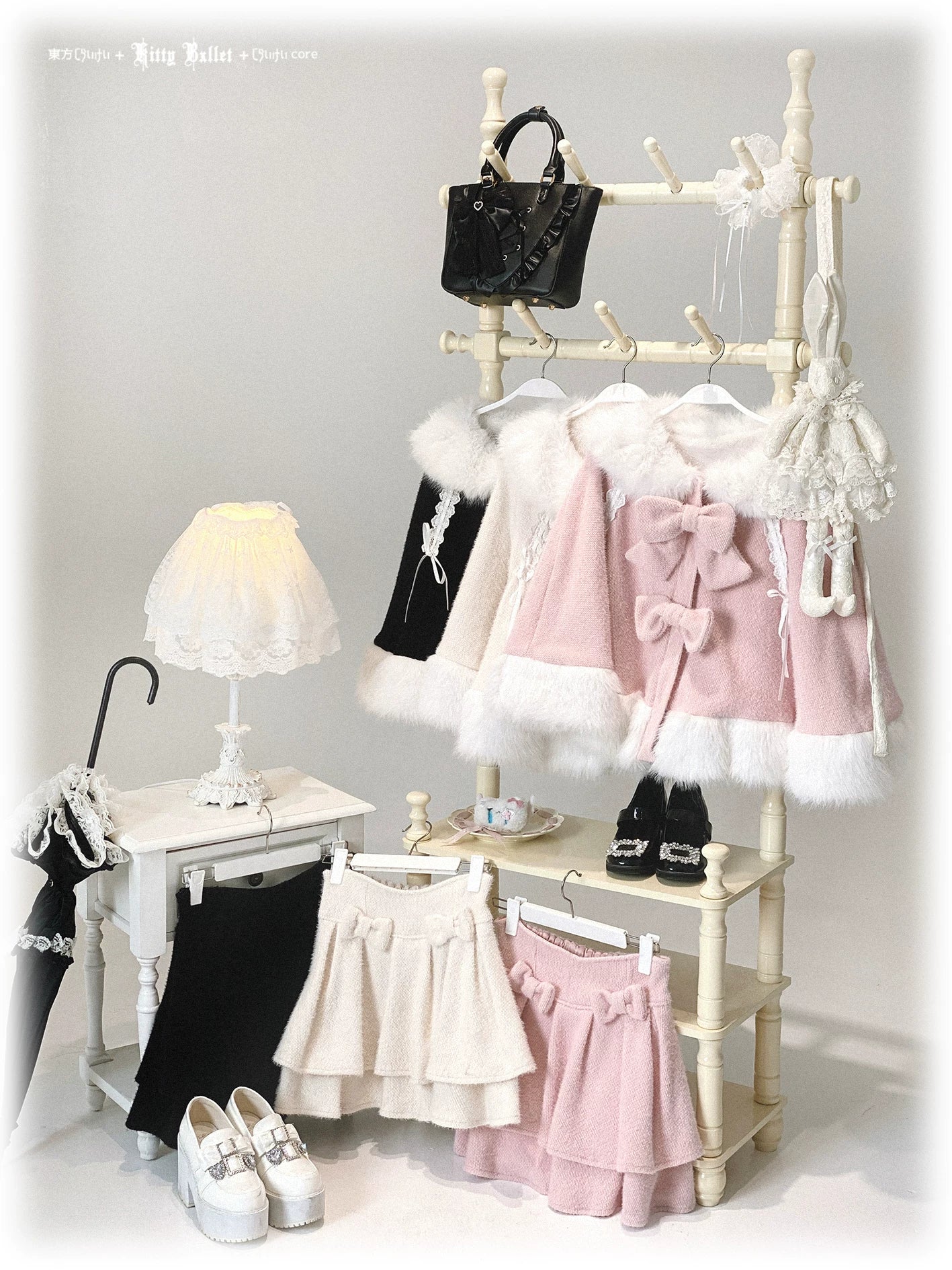 Jirai Kei lolita winter cape collection displayed on indoor boutique clothing rack with matching ruffle skirts and multi-color cape options