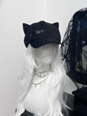 Black cat ear peaked beret cap with leather buckle detail, front oblique angle view on gothic mannequin with white curly hair, Jirai Kei fashion accessory