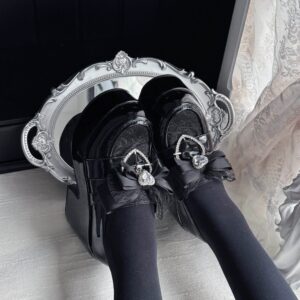 Black Jirai Kei Ryousangata platform loafers with lace toe cap and heart rhinestone bow detail, flat lay top-down view showing patent leather finish