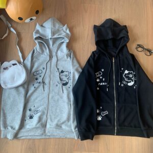Jirai Kei cat ear zip hoodie flat lay featuring bandage and fishbone print design in black and gray colorways with cute cartoon cat and paw graphics