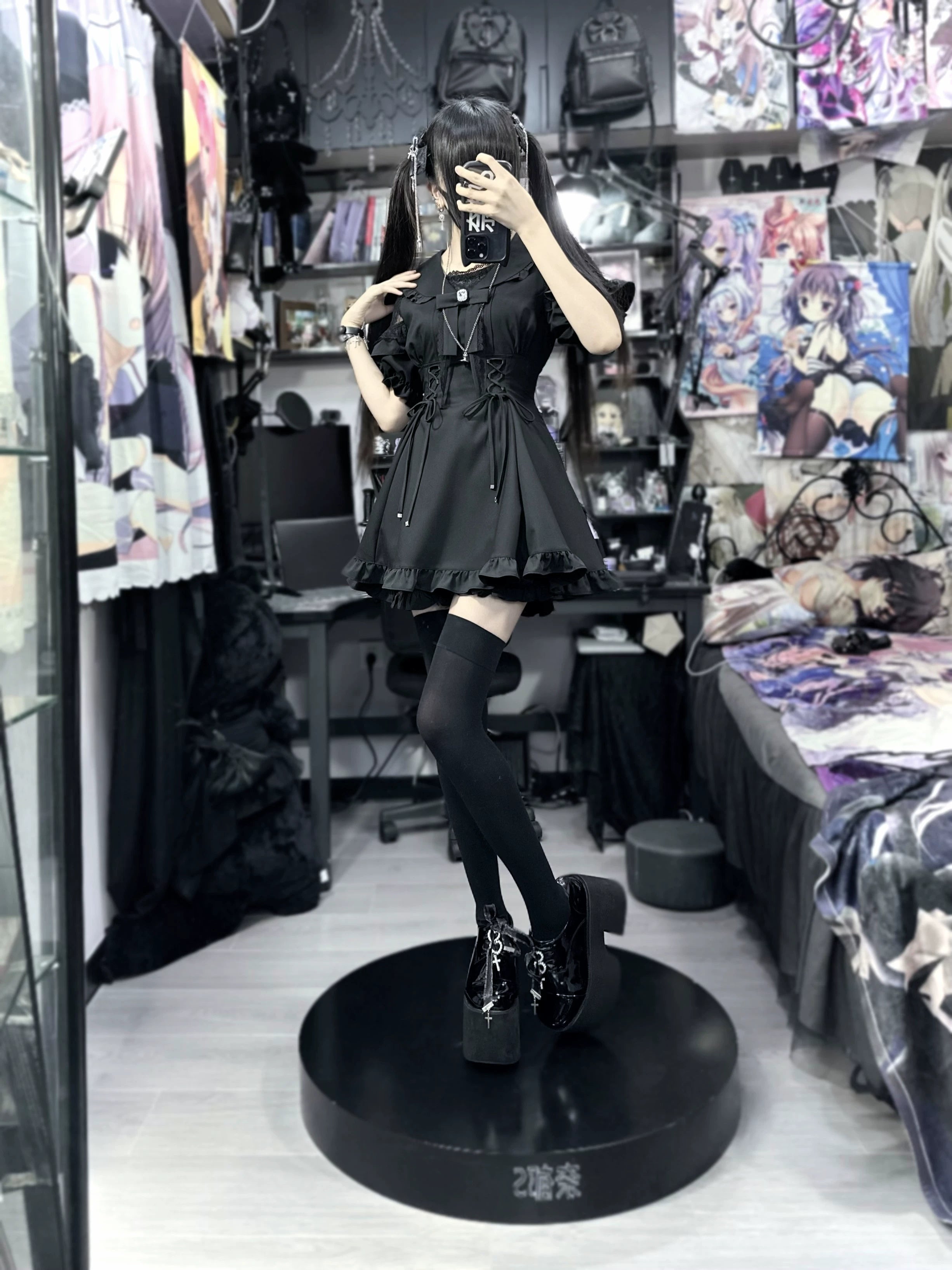 Black slim Jirai Kei dress outfit with thigh high socks platform loafers and hand-on-face pose front mirror