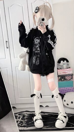 blonde model wearing black jirai kei stand collar zip jacket with white sleeve stripes and anime character print, front-side mirror selfie view in bedroom with plush decor