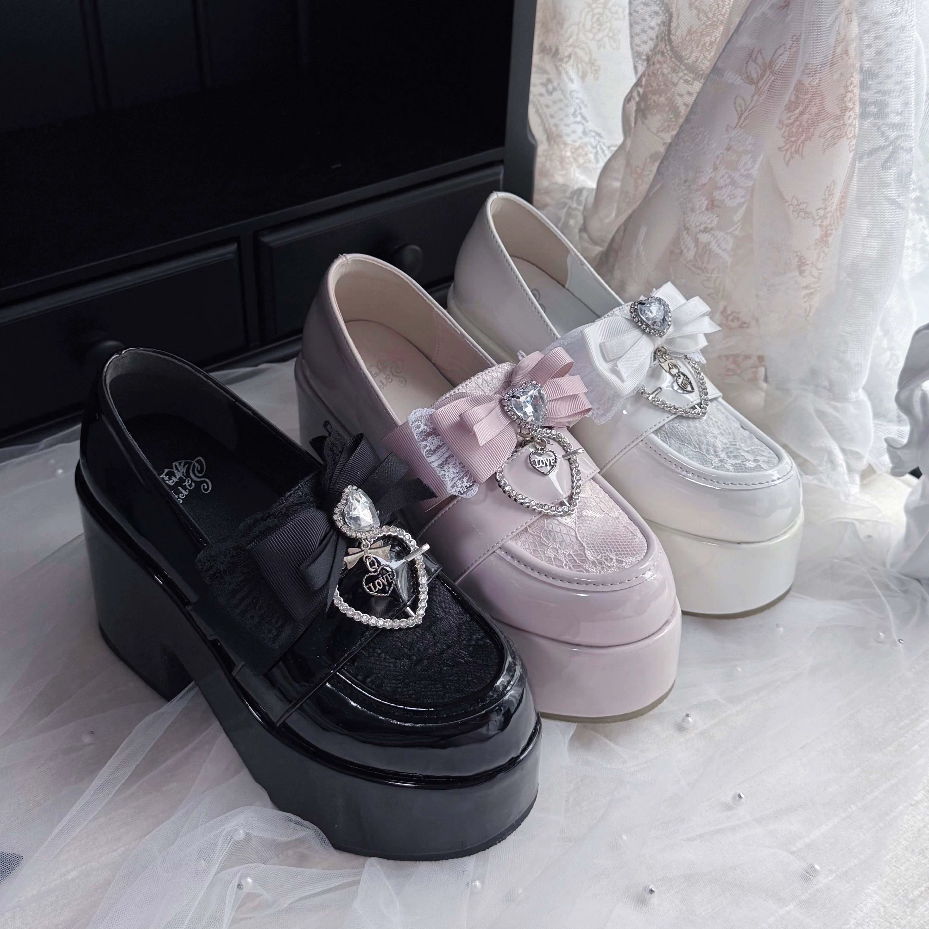 Three colorway Ryousangata platform loafers comparison in black, pink, and white showing thick platform heels and matching bow decorations, top-down flat lay