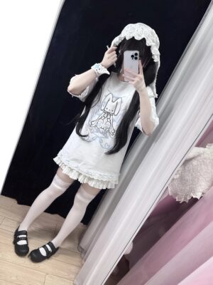 Oversized bunny print t-shirt back view showing ruffled hem lace trim worn with thigh-high stockings Mary Jane shoes fitting room mirror shot