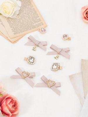 Taupe pink matte ribbon bow hair clips featuring heart-shaped rhinestone details Jirai Kei fashion accessory collection