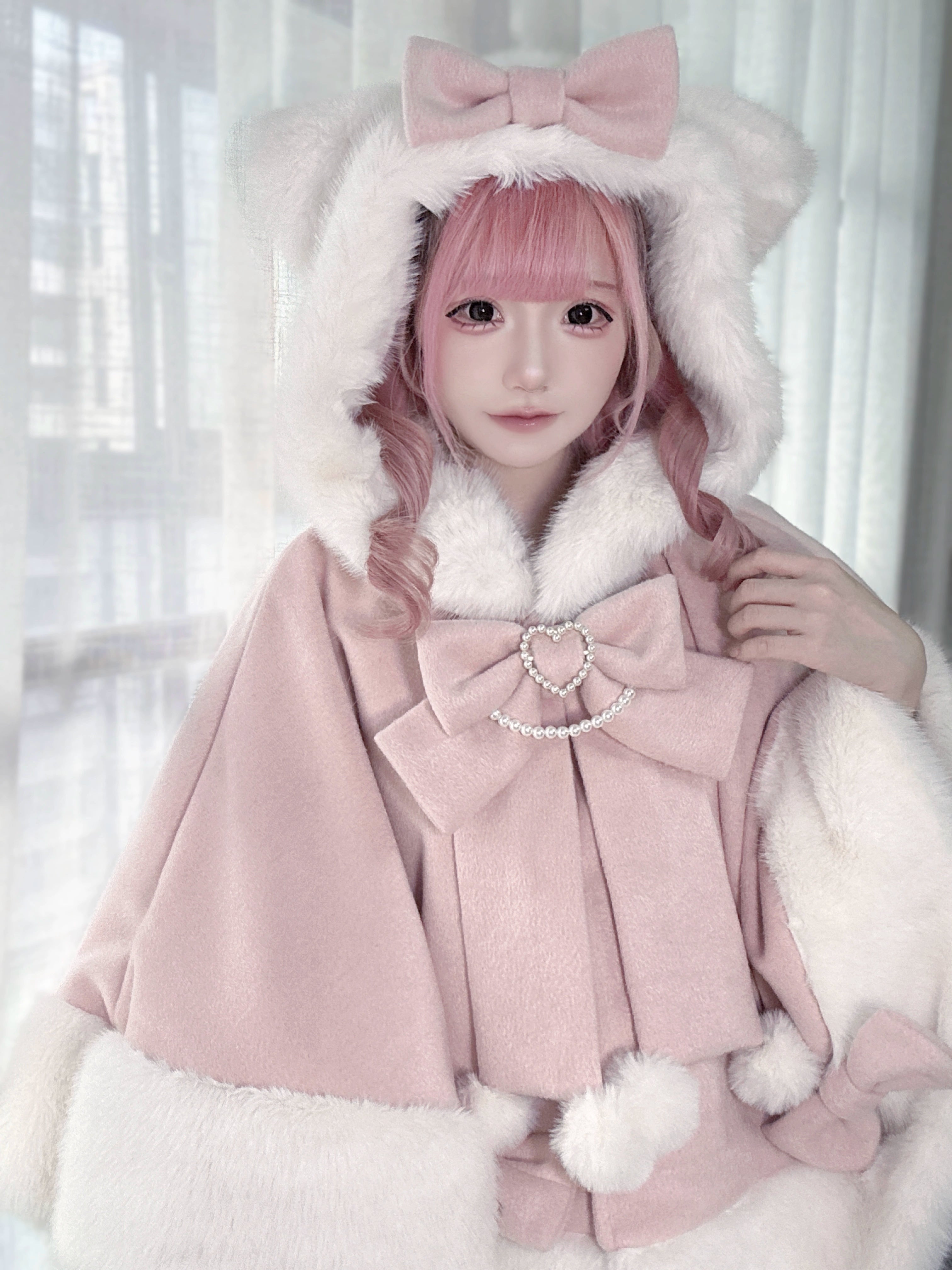 Jirai Kei pink cat ear hooded plush cape medium shot featuring large heart crystal bow and pom-pom fuzzy trim details