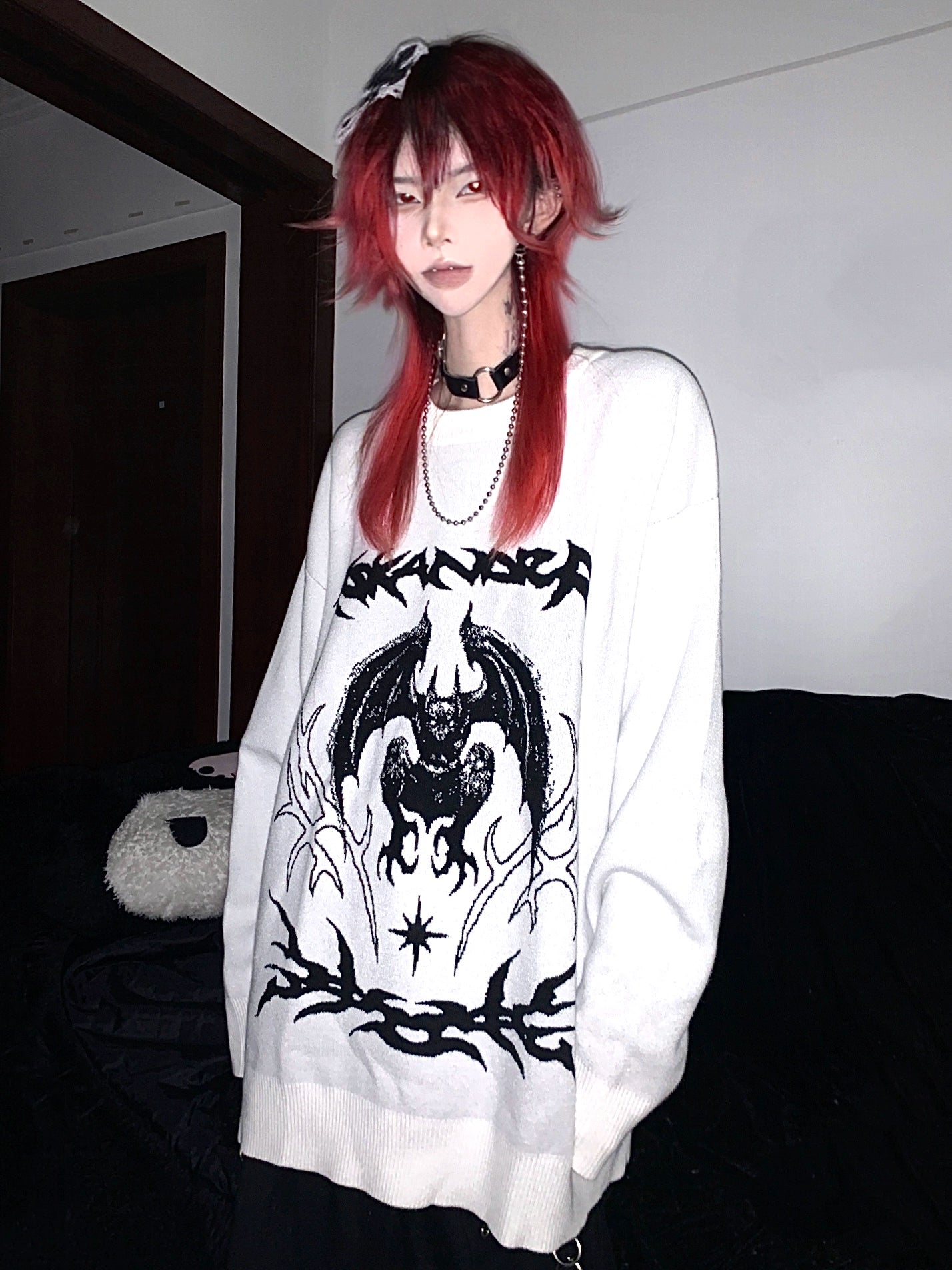 Bat embroidered sweater sleeve detail showing oversized dropped shoulder fit and fabric quality polyester knit