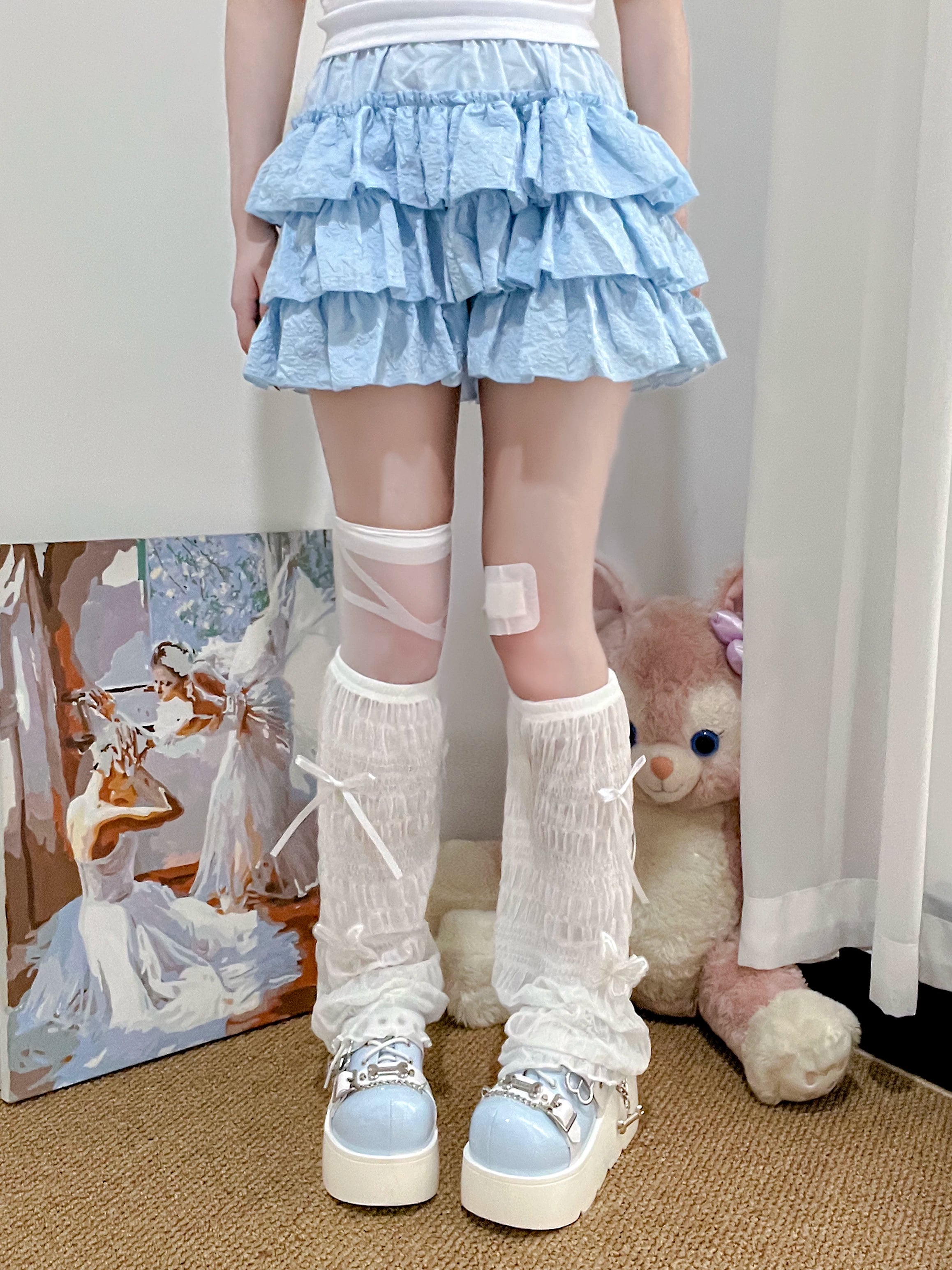 Close-up detail of Jirai Kei mesh leg warmers white ruched texture blue bow accents platform shoes