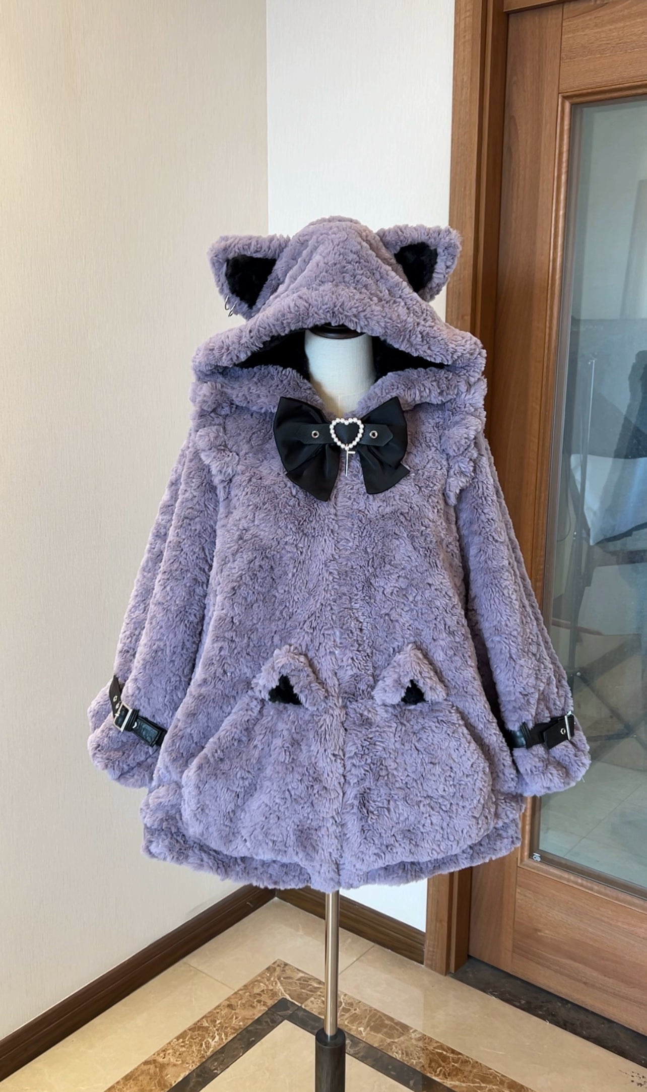 Purple plush fleece Jirai Kei coat with black cat ear hood, black heart bow, black buckle straps on sleeves, and cat ear pocket details, front view