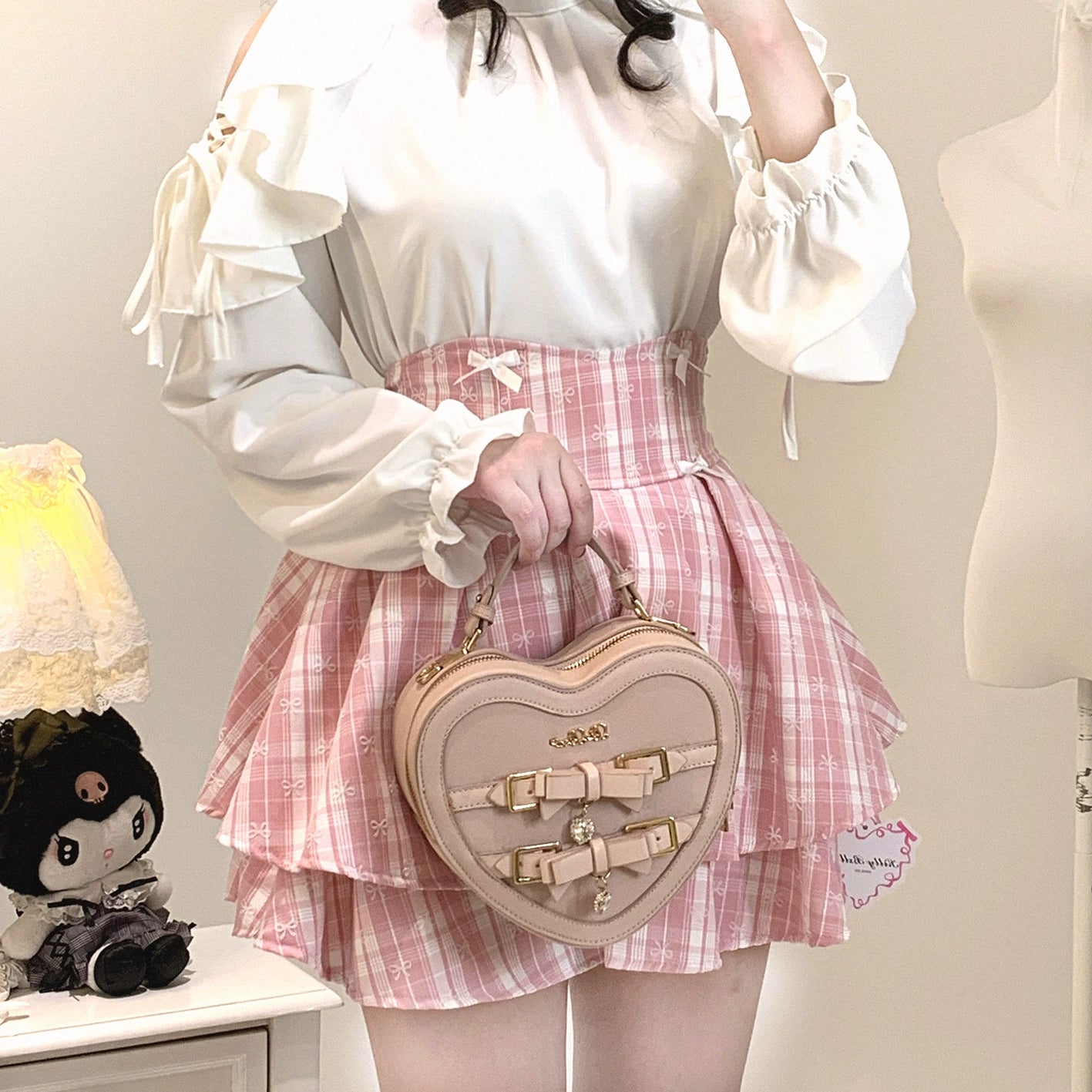 White elegant cold-shoulder ruffled blouse Jirai Kei with pink plaid skirt heart-shaped handbag coordinate