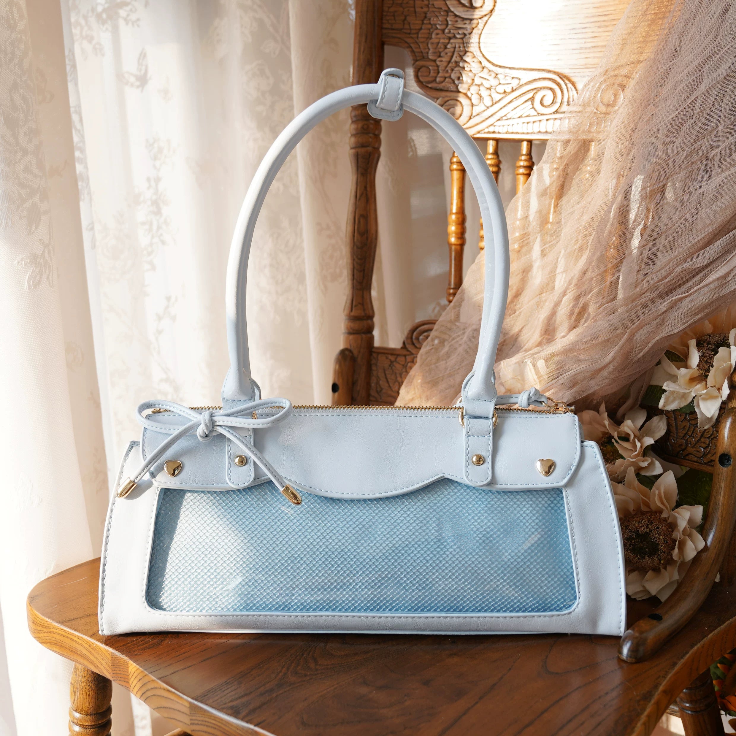 Blue baguette itabag with transparent acrylic display window for collectible badges and adjustable shoulder strap