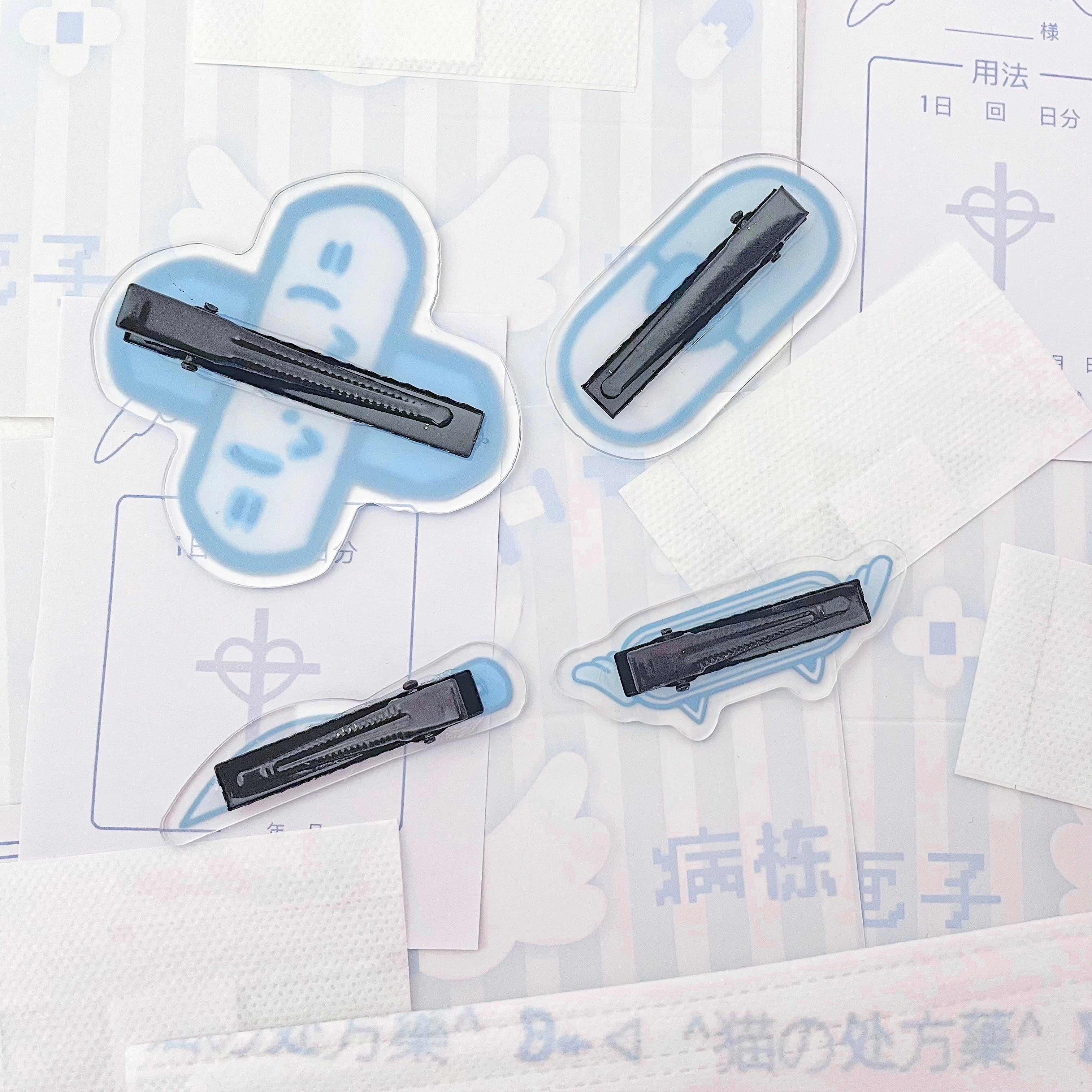 Tenshi Kaiwai individual acrylic hair clip models numbered 1-5 showing each unique medical cat knife bandage design
