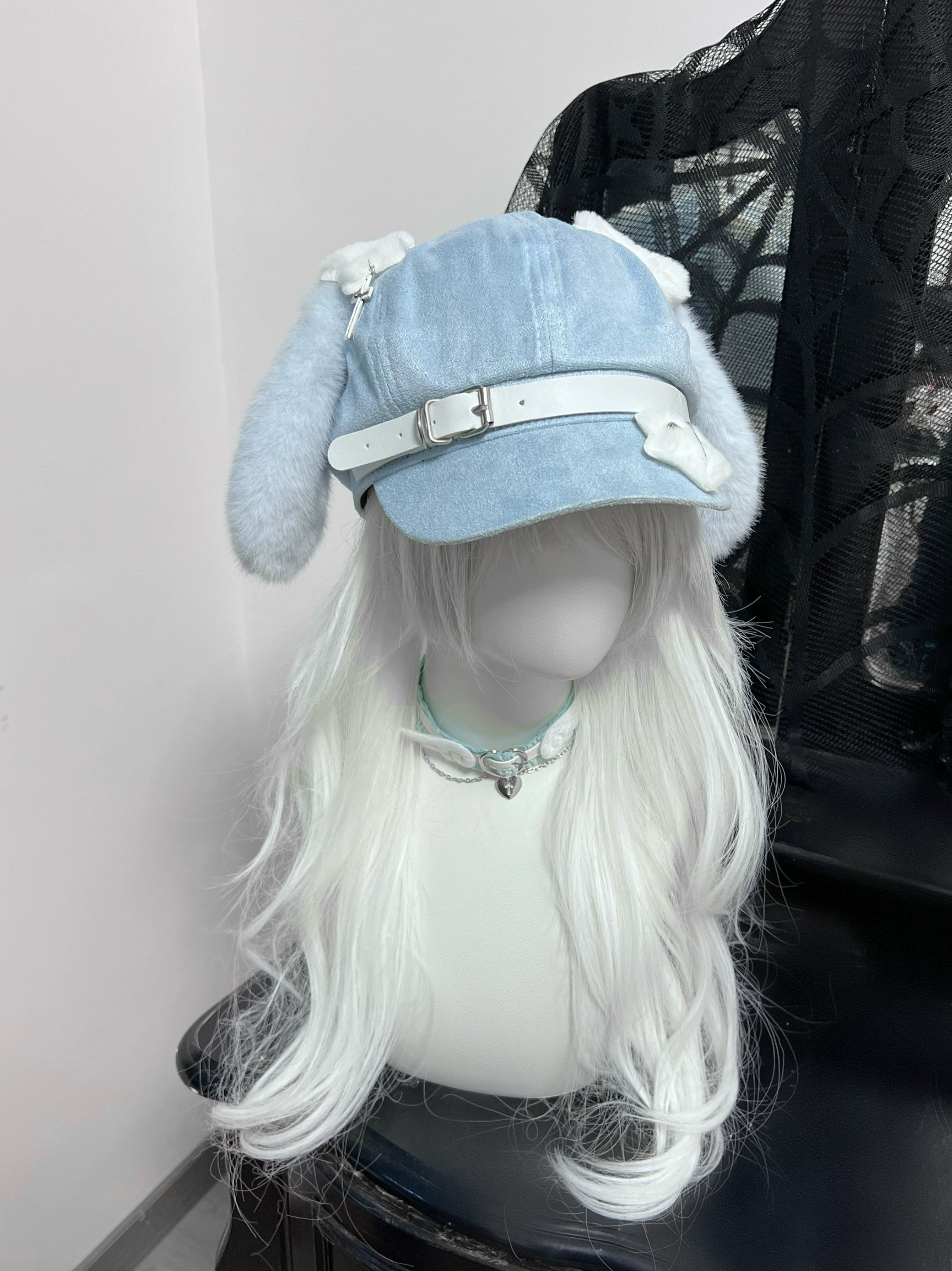 Front static display of blue puppy ear beret on mannequin with long white wig, showing denim blue color and fluffy ear details