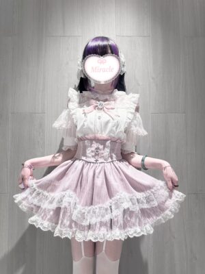 Sweet Lolita pink white off-shoulder blouse with ruffle sleeves and bow brooch on model indoor wooden background Jirai Kei style