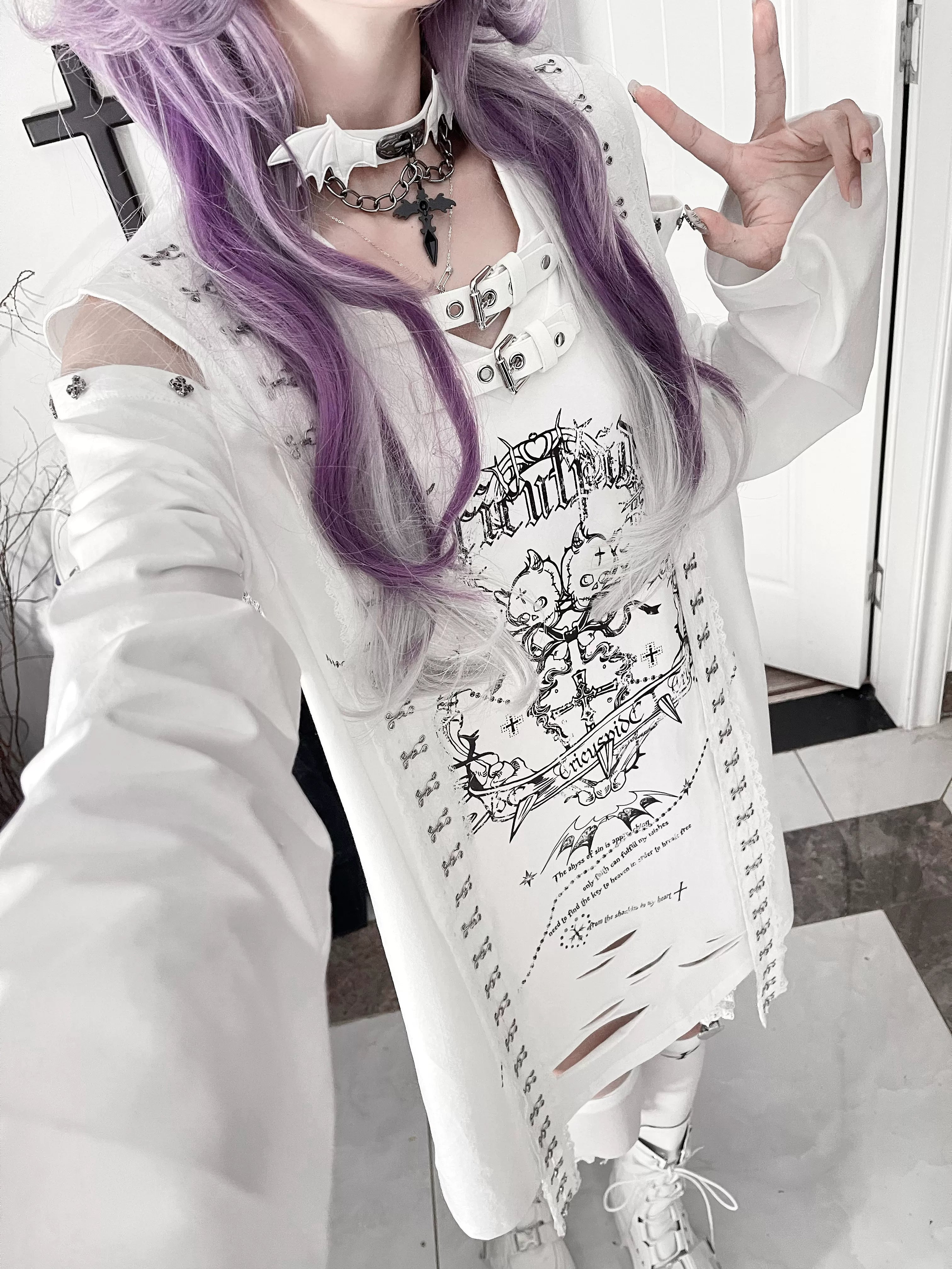 Back view of black goth long-sleeve tee with cut-out shoulders and distressed hemline, showcasing full silhouette and construction quality of Jirai Kei statement piece