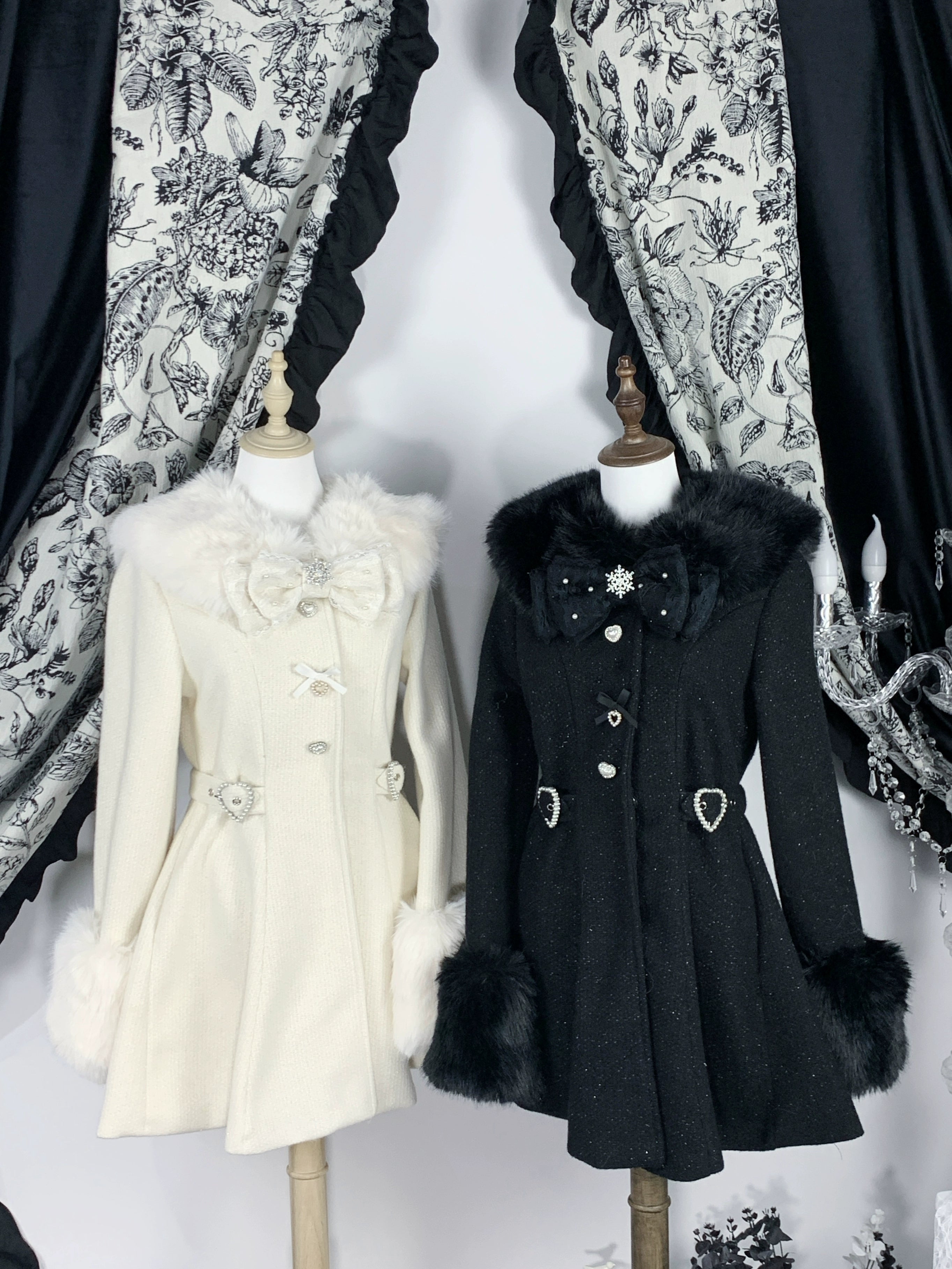 Two Ryousangata tweed winter coats displayed side by side on mannequins beige and black with detachable fur trims flat front view vintage backdrop