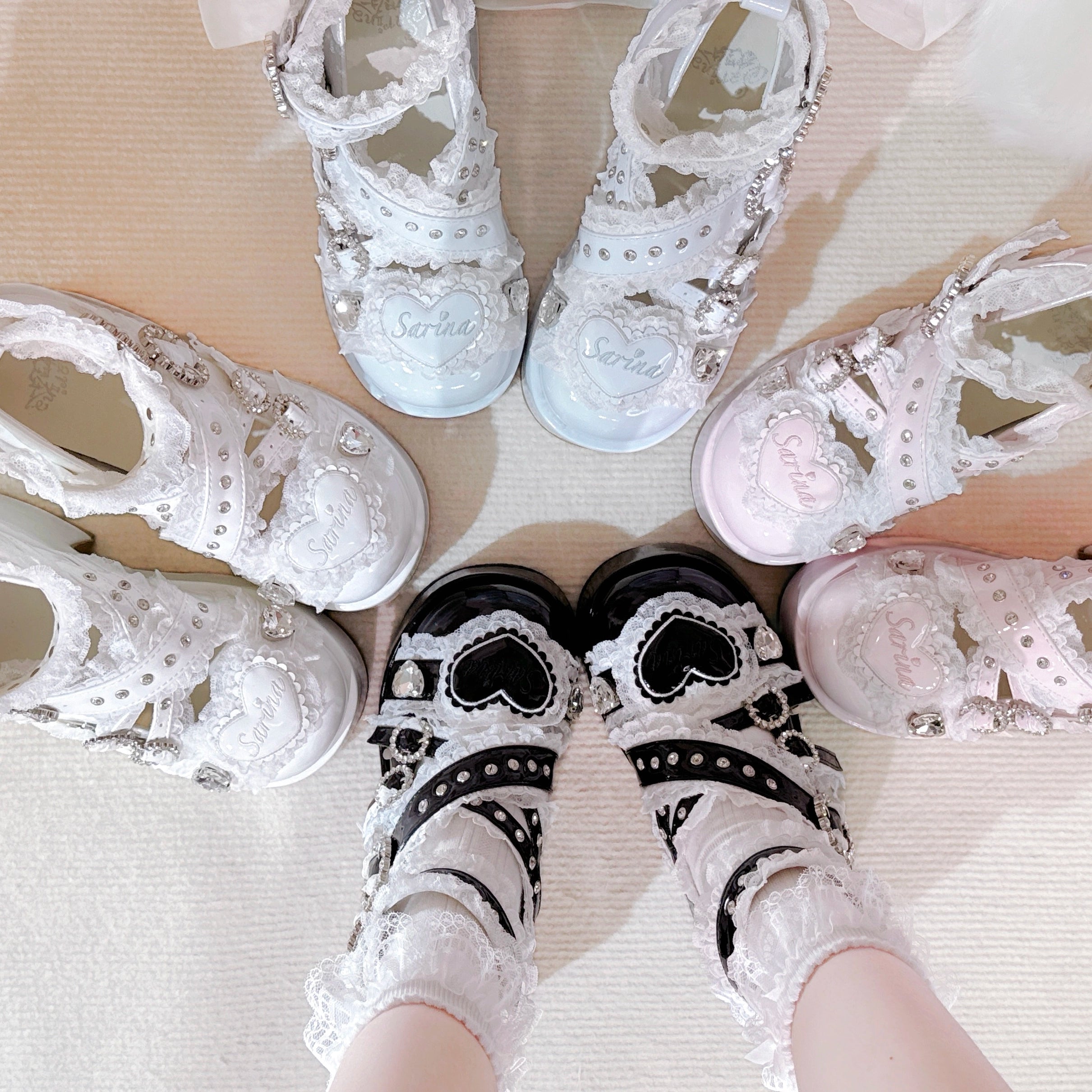 White heart-shaped Jirai Kei platform shoes with lace socks flat lay top down view cutout design