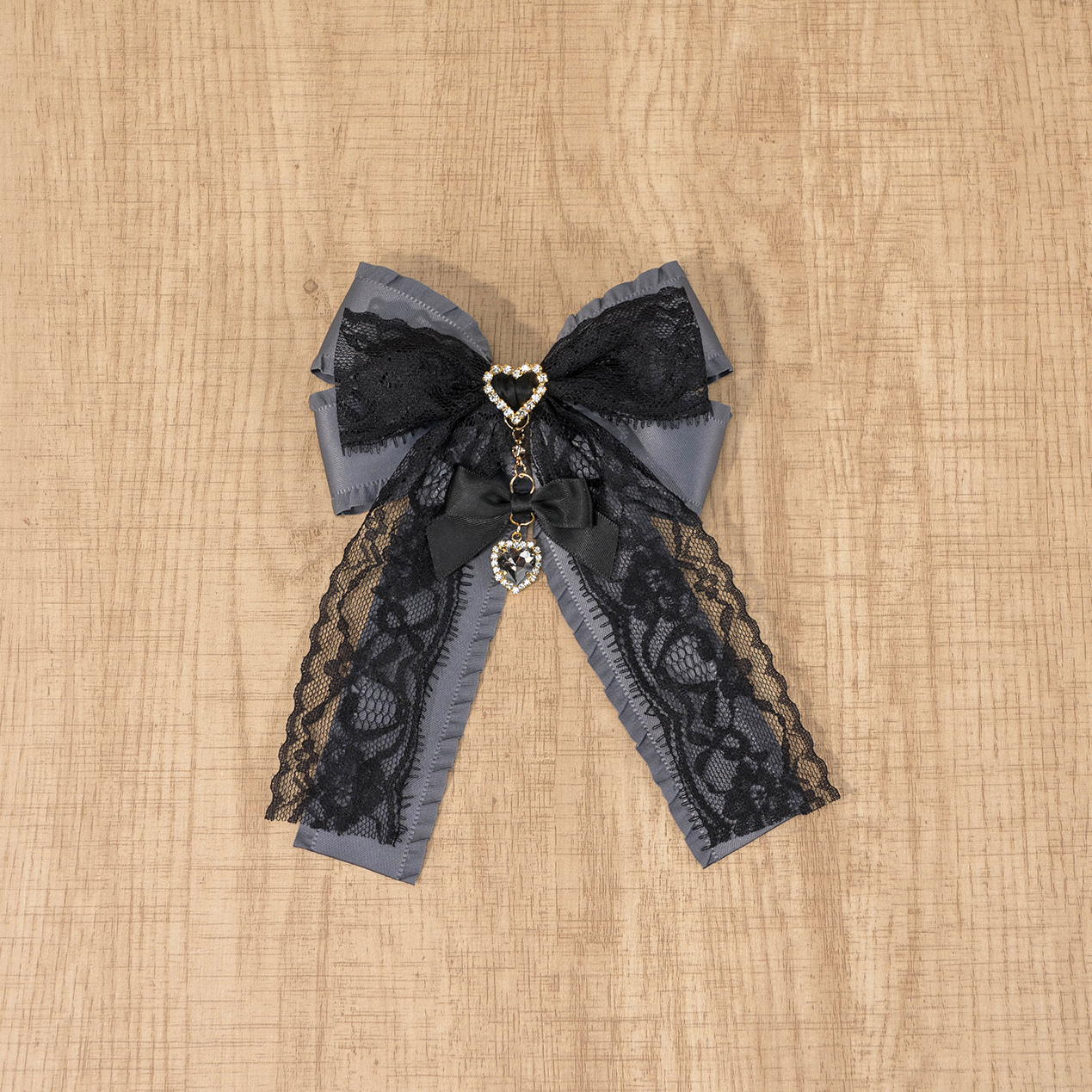 Black and grey reversible Jirai Kei lace double bow brooch with rhinestone heart, showing layered bow construction and color variation