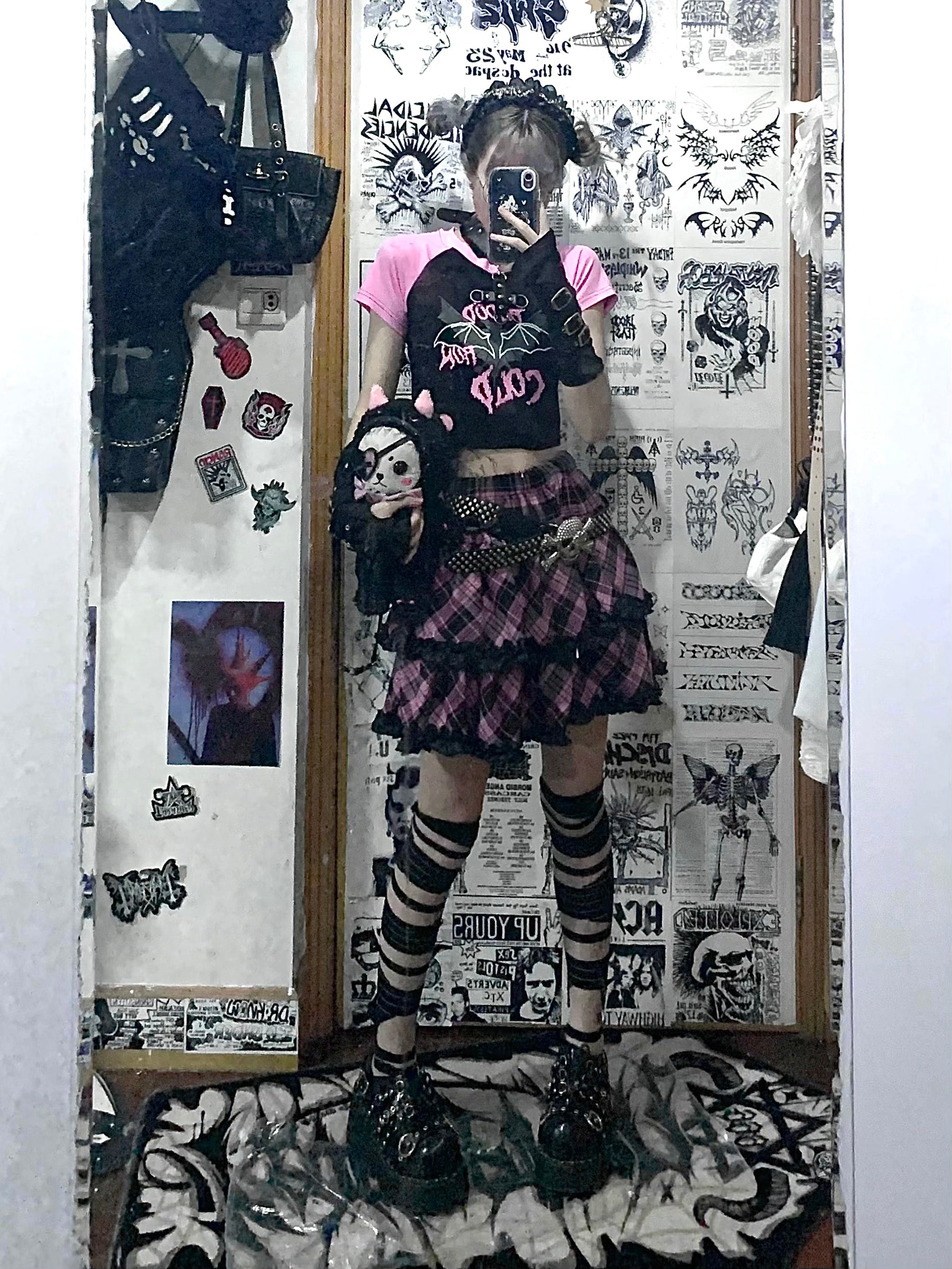 Dark pink-black plaid Jirai Kei mini ruffle skirt mirror selfie with punk model wearing pink-sleeved crop top and matching striped socks