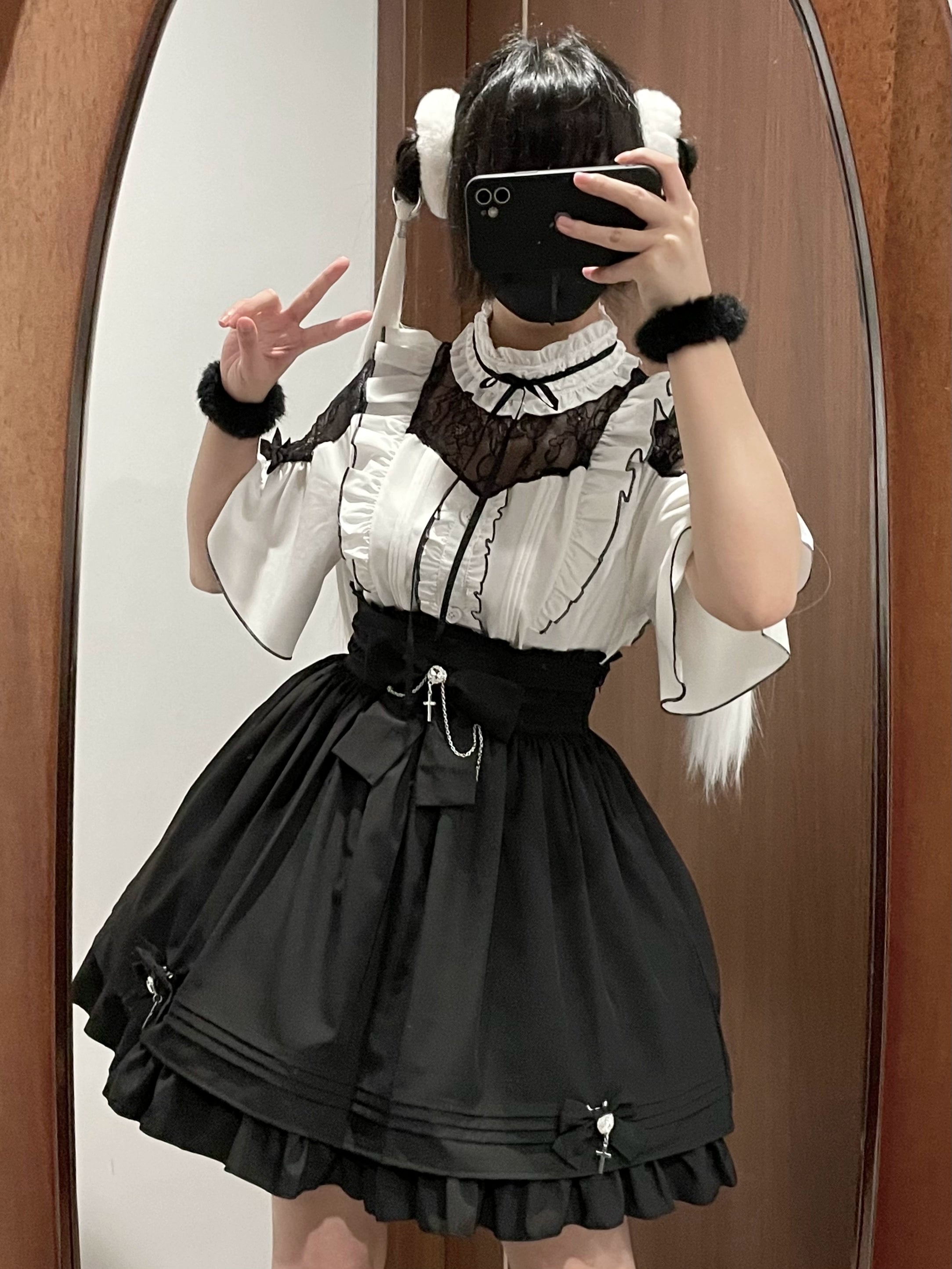 Jirai kei lace-shoulder blouse and high-waist skirt set in black and white color combination featuring rhinestone cross pendant and detachable bow decorations