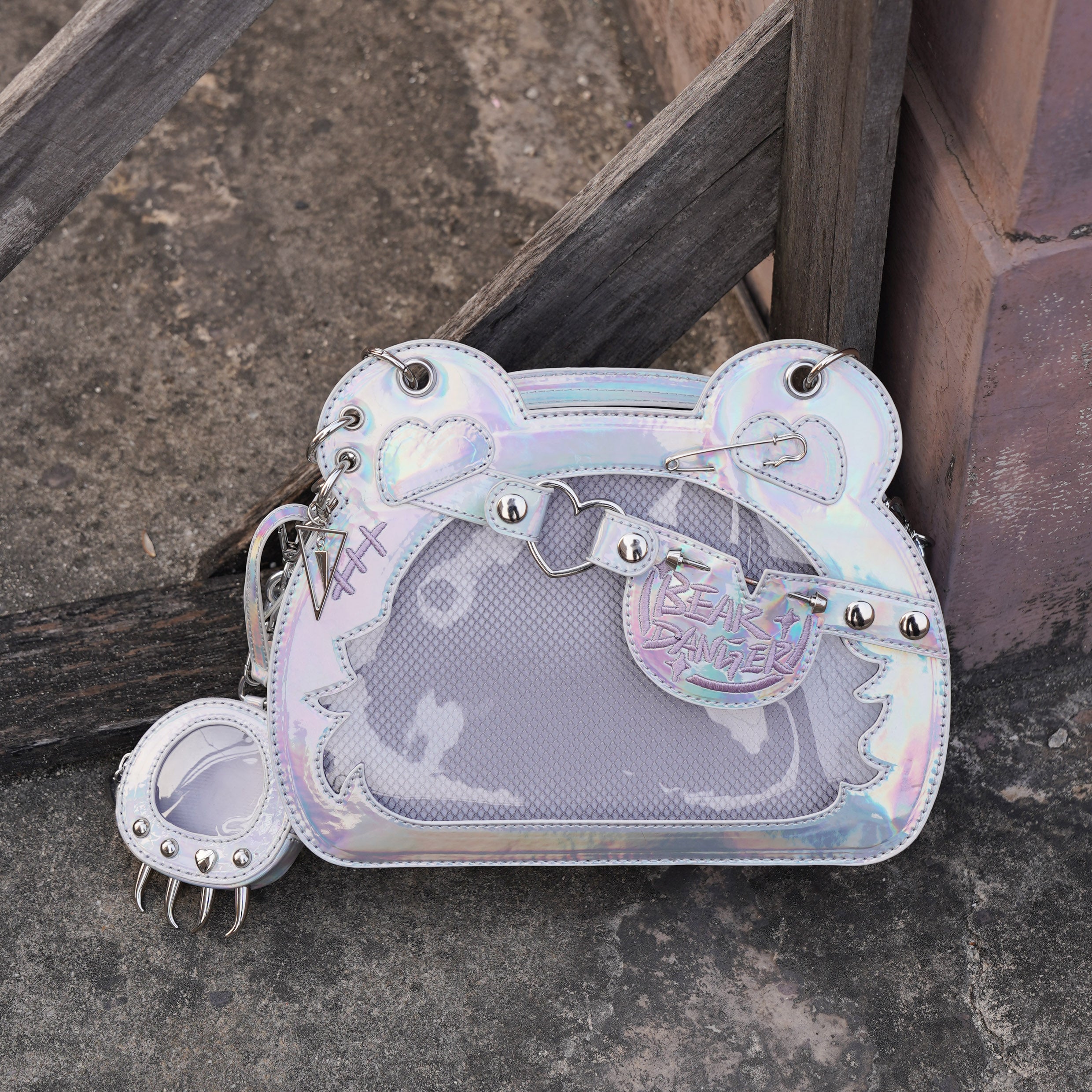 Holographic iridescent white laser silver bear-shaped jirai kei ita bag with punk metal accessories and matching paw coin pouch