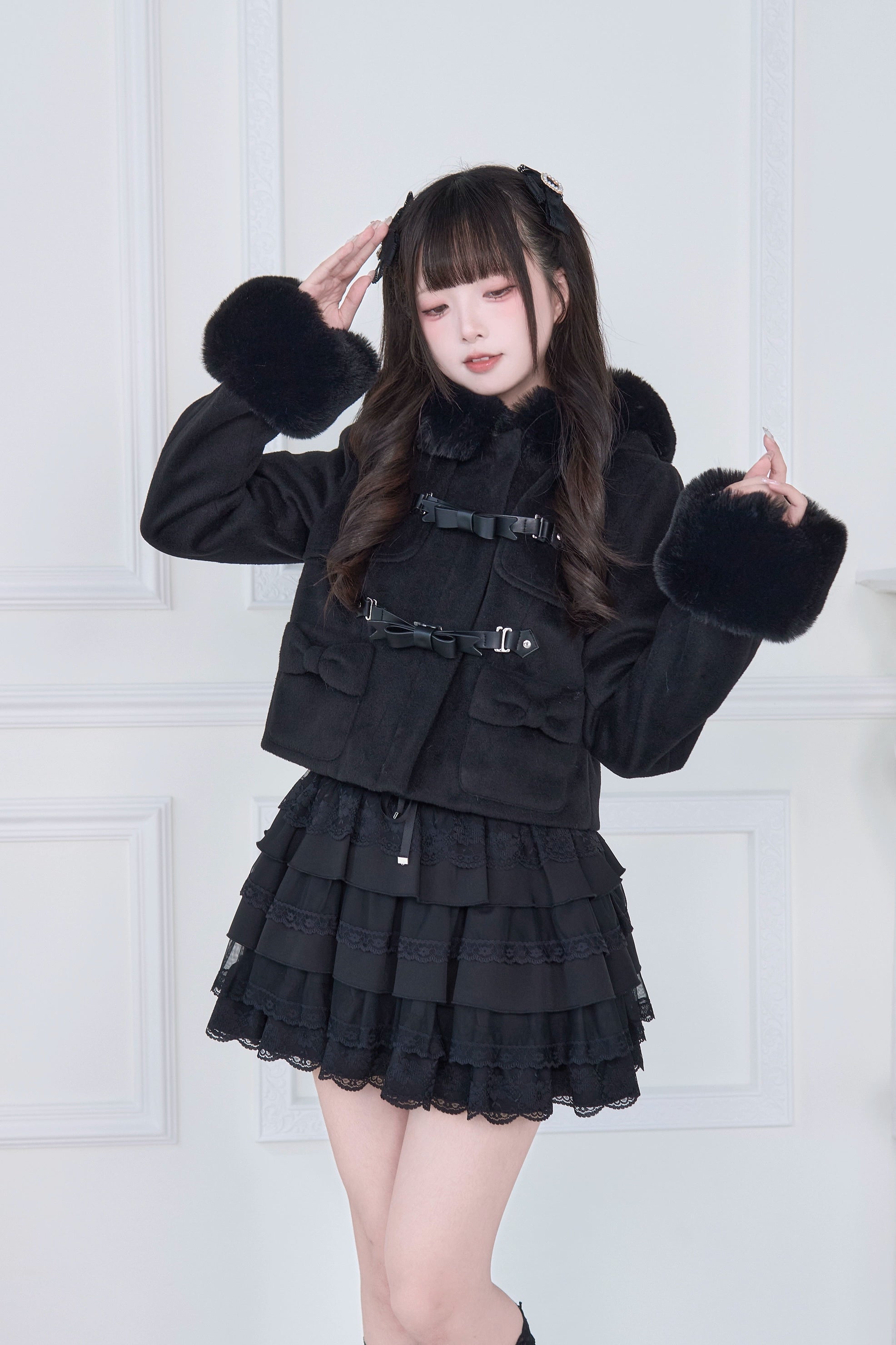 Black hooded rousangata cropped coat flat lay product photography, showing full coat silhouette, hood, detachable cuffs, and structural design of jirai kei statement piece