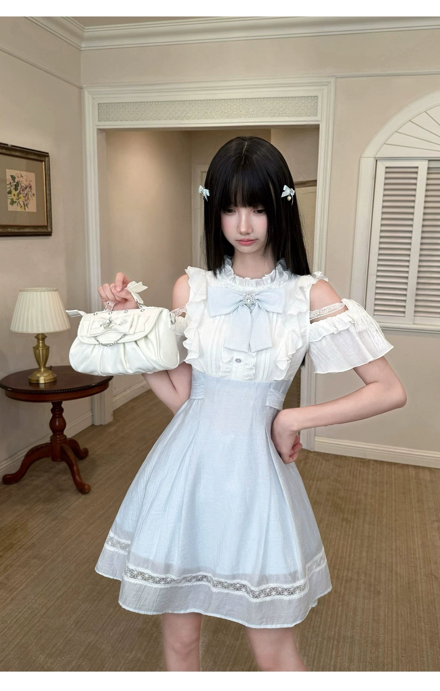Seiso Kei short cold-shoulder dress front view with chest bow decoration, ruffled short sleeves, and lace hem in vintage room